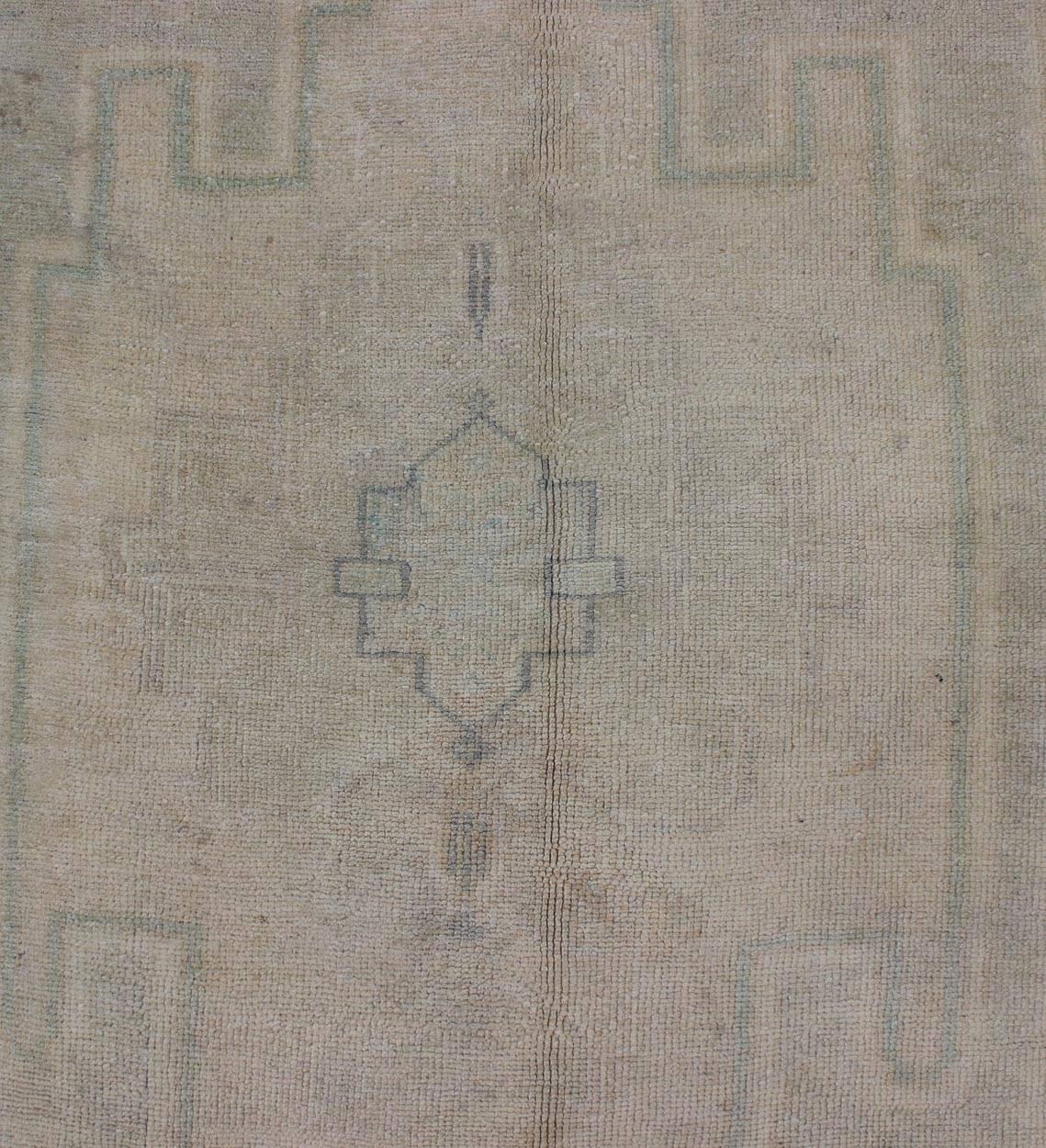 Wool Pale Color Turkish Oushak Rug with Geometric Motifs in Light Brown, Tan & Green For Sale