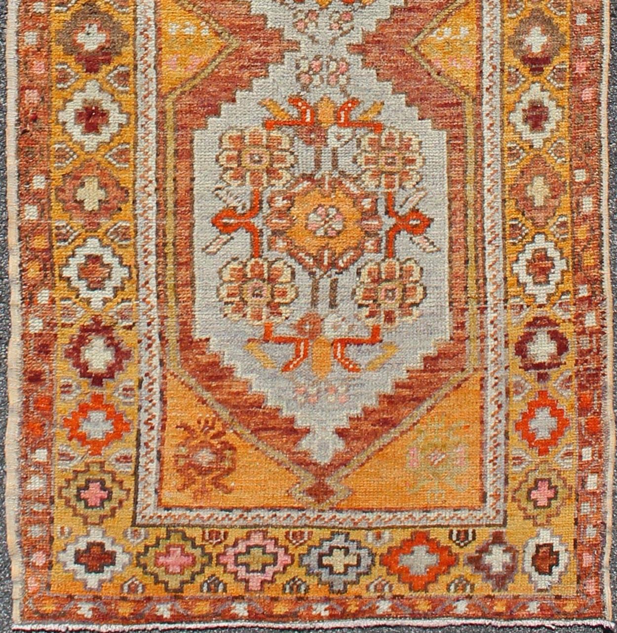 Colorful antique Turkish runner with four medallions in yellow, red, green, gray, rug en-486, country of origin / type: turkey / Oushak, circa 1930s 

This beautiful antique Oushak runner from early 20th century turkey features a classic Oushak