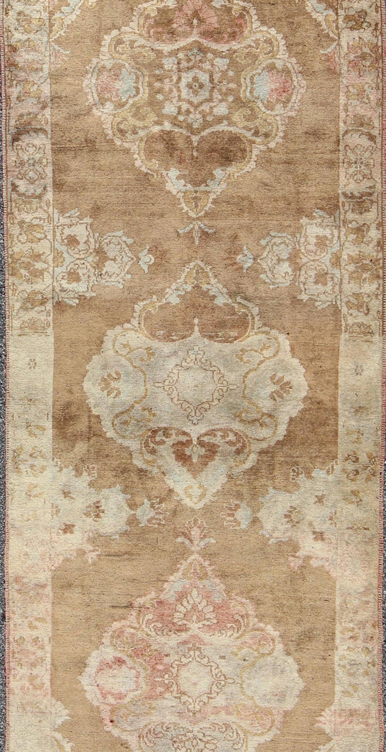 Hand-Knotted Vintage Turkish Oushak Runner with Floral Medallions in Light Brown and Ivory For Sale