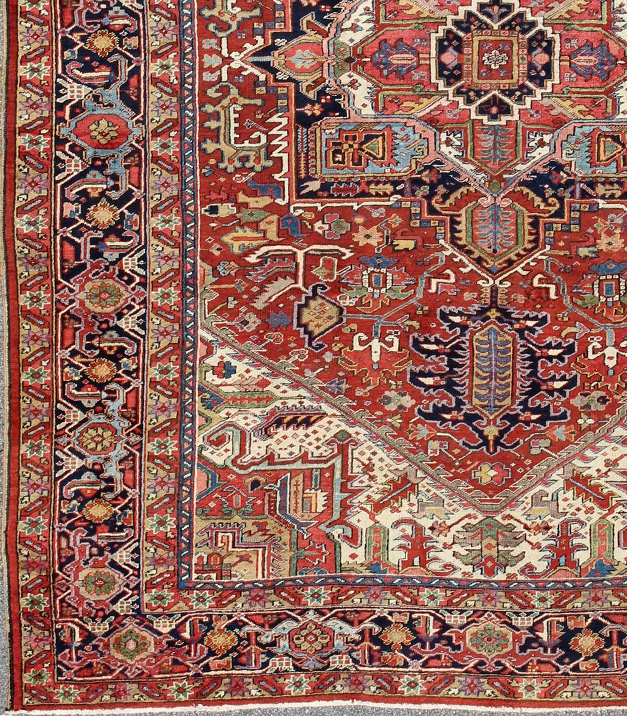 Antique Heriz-Serapi Rug with Geometric Medallion in Rust Red, Dark Blue, Green. Keivan Woven Arts / Rug / A-0203, country of origin / type: Iran /Heriz, circa 1910. 
Measures: 10'3 x 13'3.
This magnificent antique Persian Heriz-Serapi carpet from