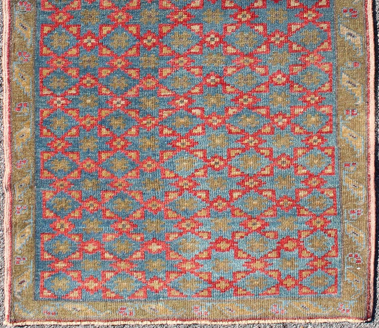 Turkish Konya rug with all-over floral Lattice design in red, blue, olive green, rug dur-3418, country of origin / type: Turkey / Oushak, circa mid-20th century.

Measures: 3'4 x 6'10

The design of this beautiful vintage Konya rug from mid-20th