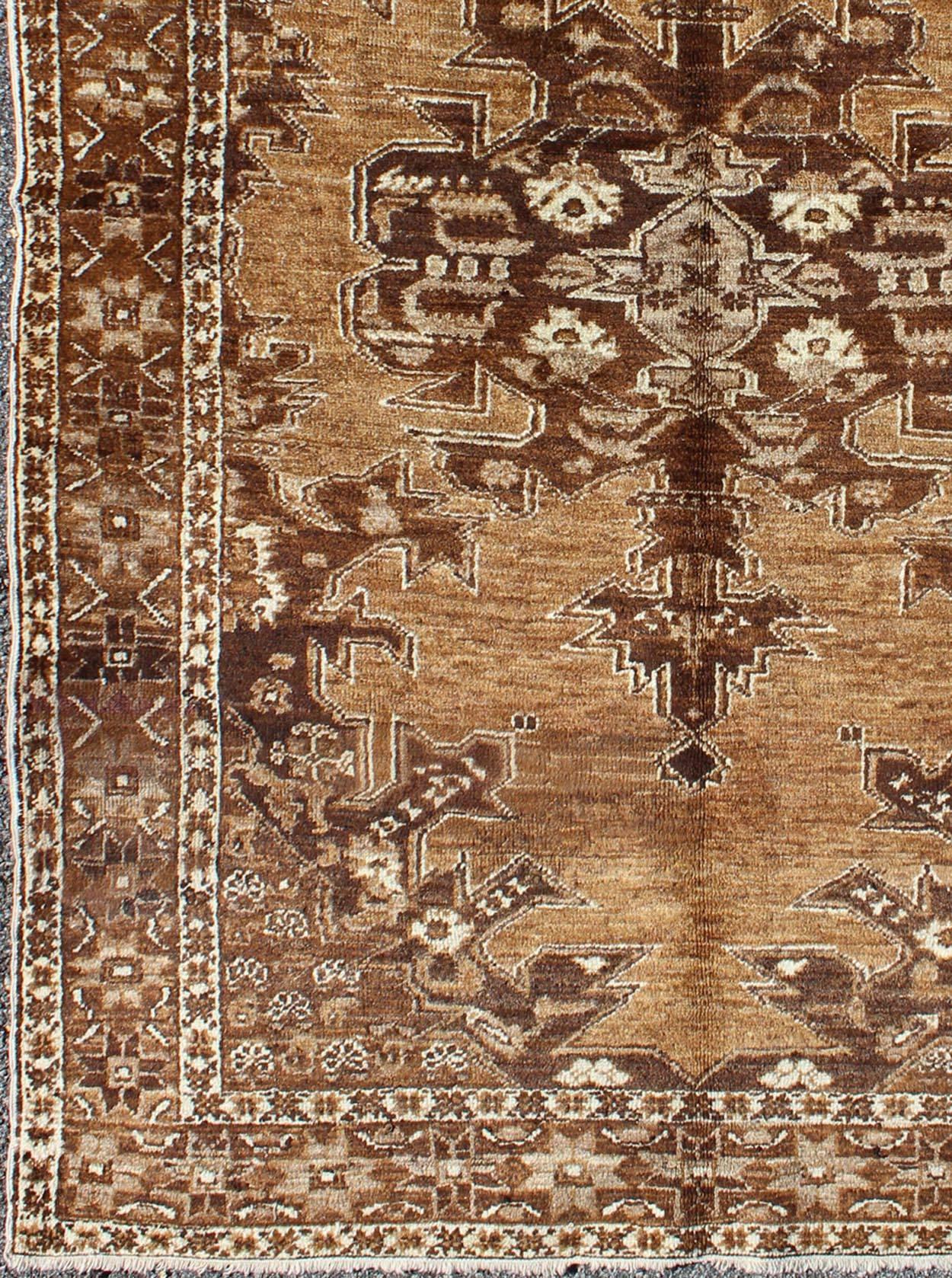 Brown Mid-Century vintage Turkish Oushak rug with floral multi-layered medallion, rug/EYP-4 , country of origin/type: Turkey/Oushak, circa 1930's century.
This antique Turkish Oushak carpet  features a central, multi-layered medallion design, as