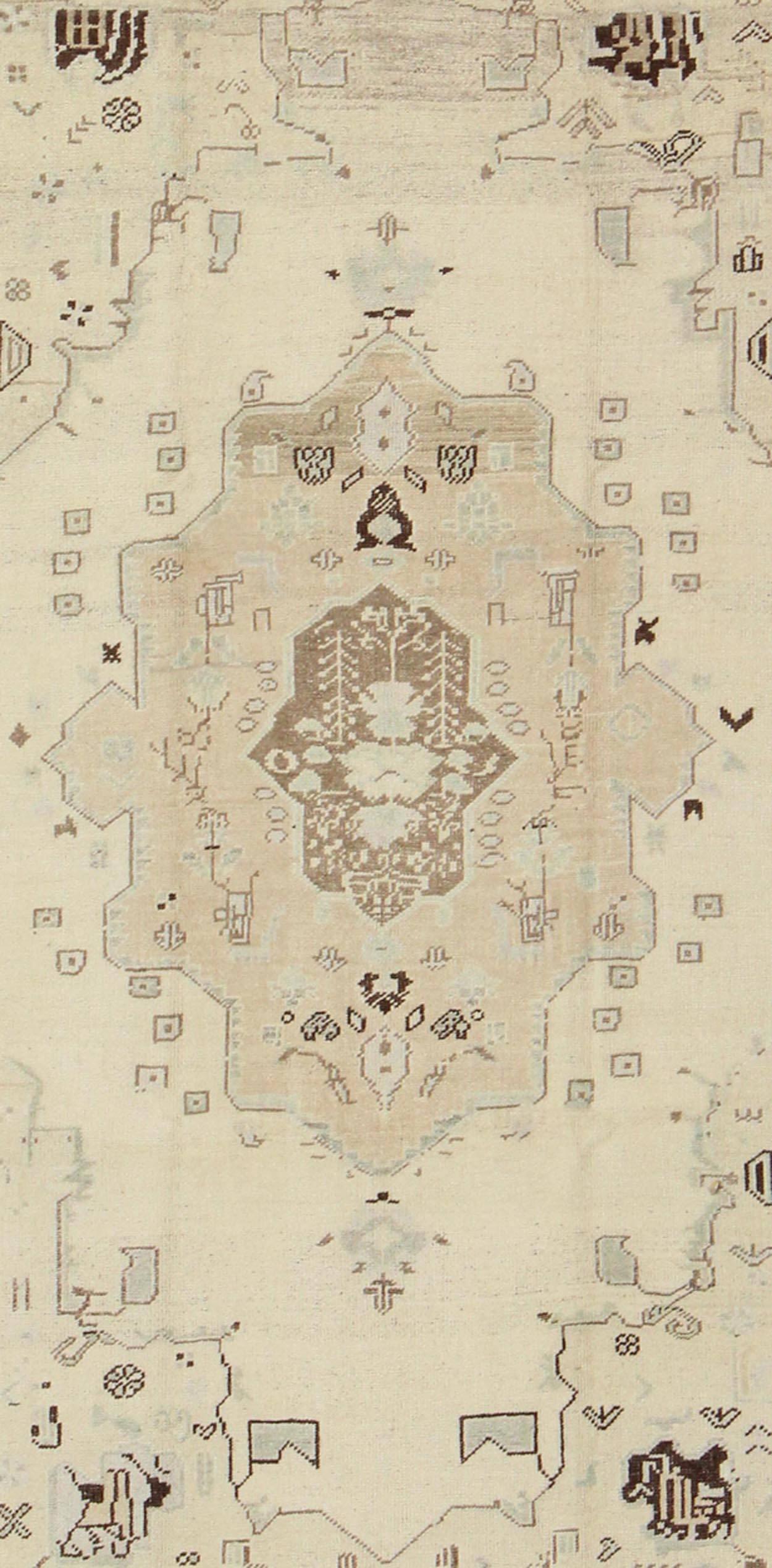 Hand-Knotted Ivory Background Vintage Turkish Oushak Rug with Tribal Medallion and Motifs For Sale