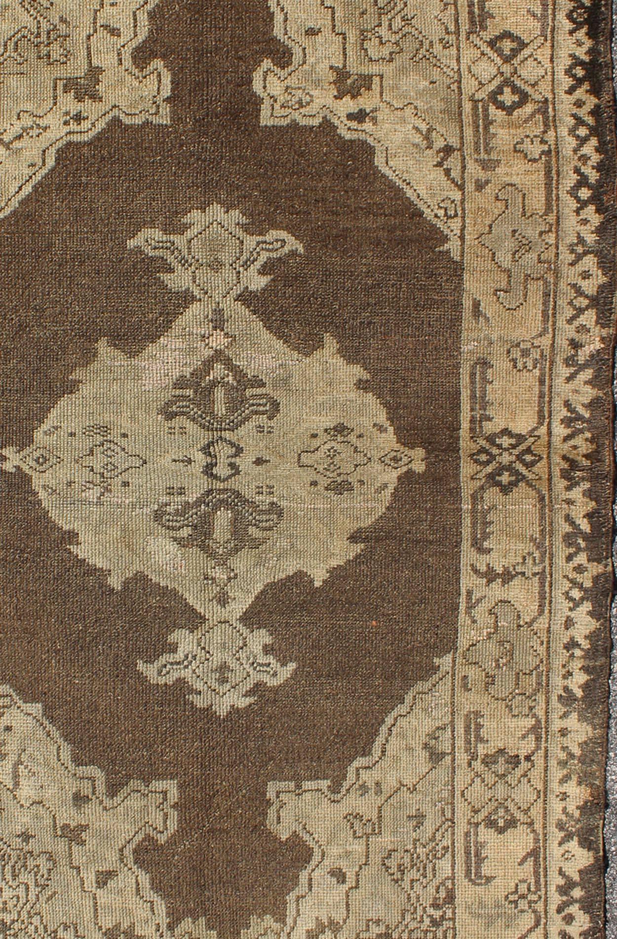 Chocolate Background Vintage Turkish Oushak Rug with Floral Medallion in Cream In Good Condition For Sale In Atlanta, GA