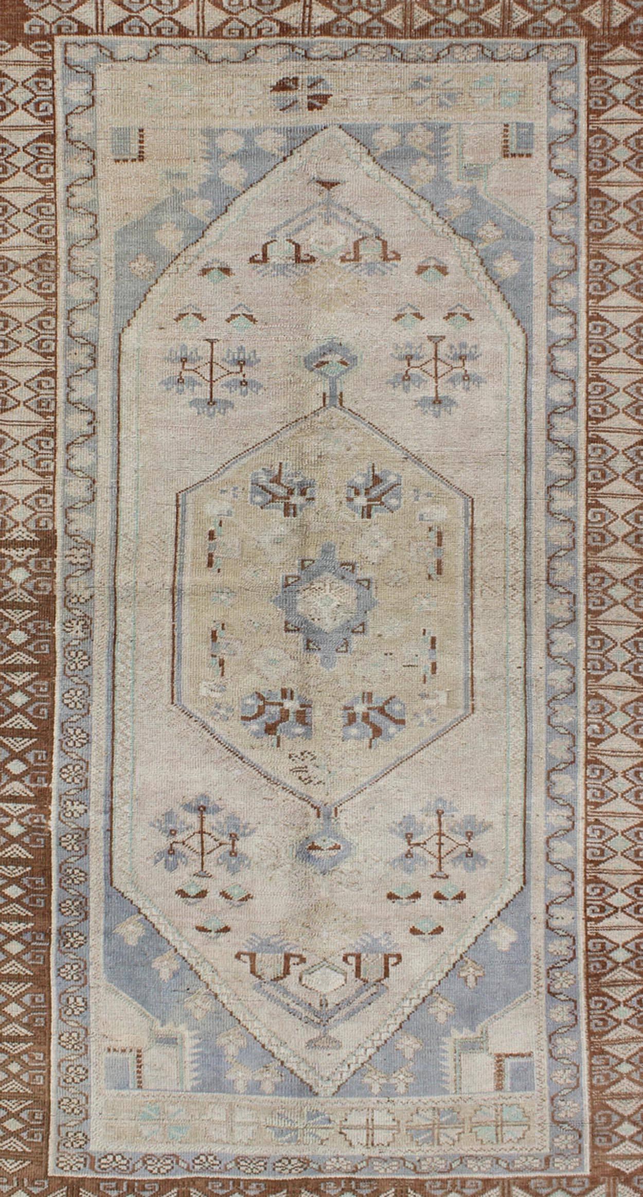 Hand-Knotted Vintage Turkish Oushak Rug with Tribal Motifs and Medallion For Sale