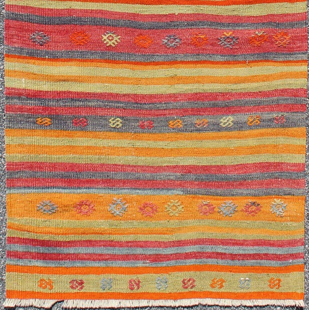 Vintage Turkish Oushak rug with geometric tribal designs and colorful stripes, rug ned-119, country of origin / type: Turkey / Kilim, circa mid-20th century

Featuring tribal shapes rendered in a repeating horizontal stripe design, this unique