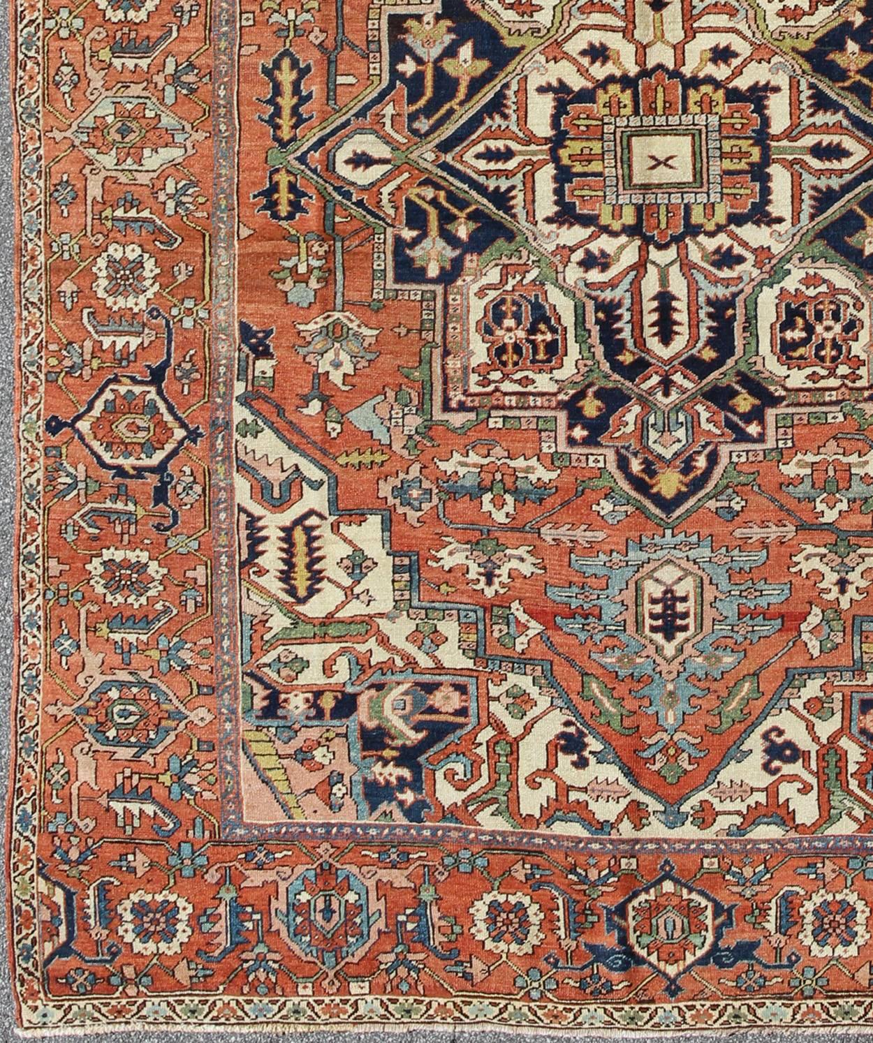 Antique Persian Serapi rug with bold medallion in orange, navy blue and green. kwarugs / S12-0201. This magnificent antique Persian Serapi from the late 19th century bears an exquisite design rendered in gorgeous, warm hues of rust, green, and denim