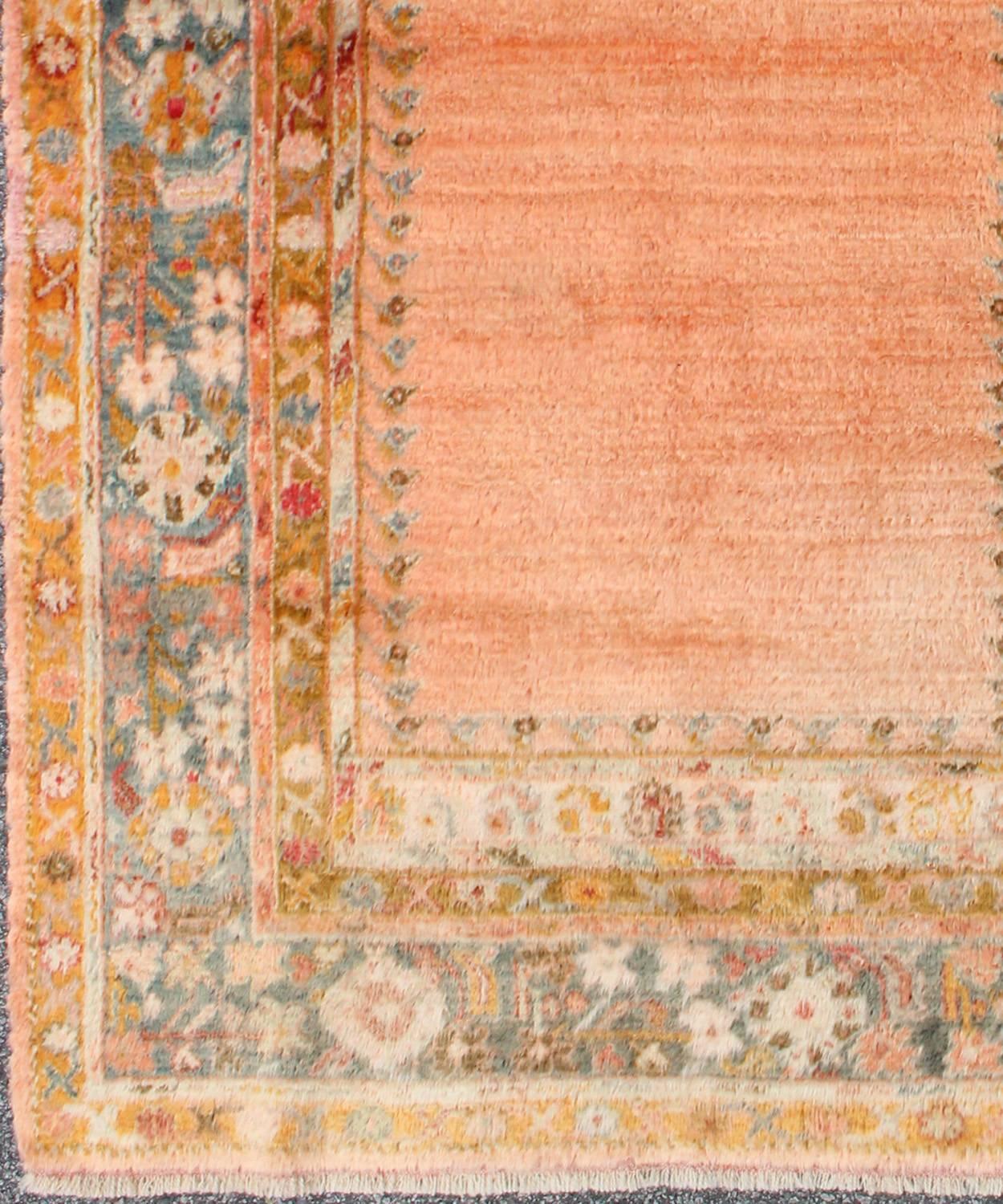 Antique Angora wool Oushak rug with solid salmon field and intricate borders, rug 17-0706, country of origin/type: Turkey/Oushak, circa 1900.

This antique Turkish rug (circa 1900) features a relatively intricate and detailed border area and an