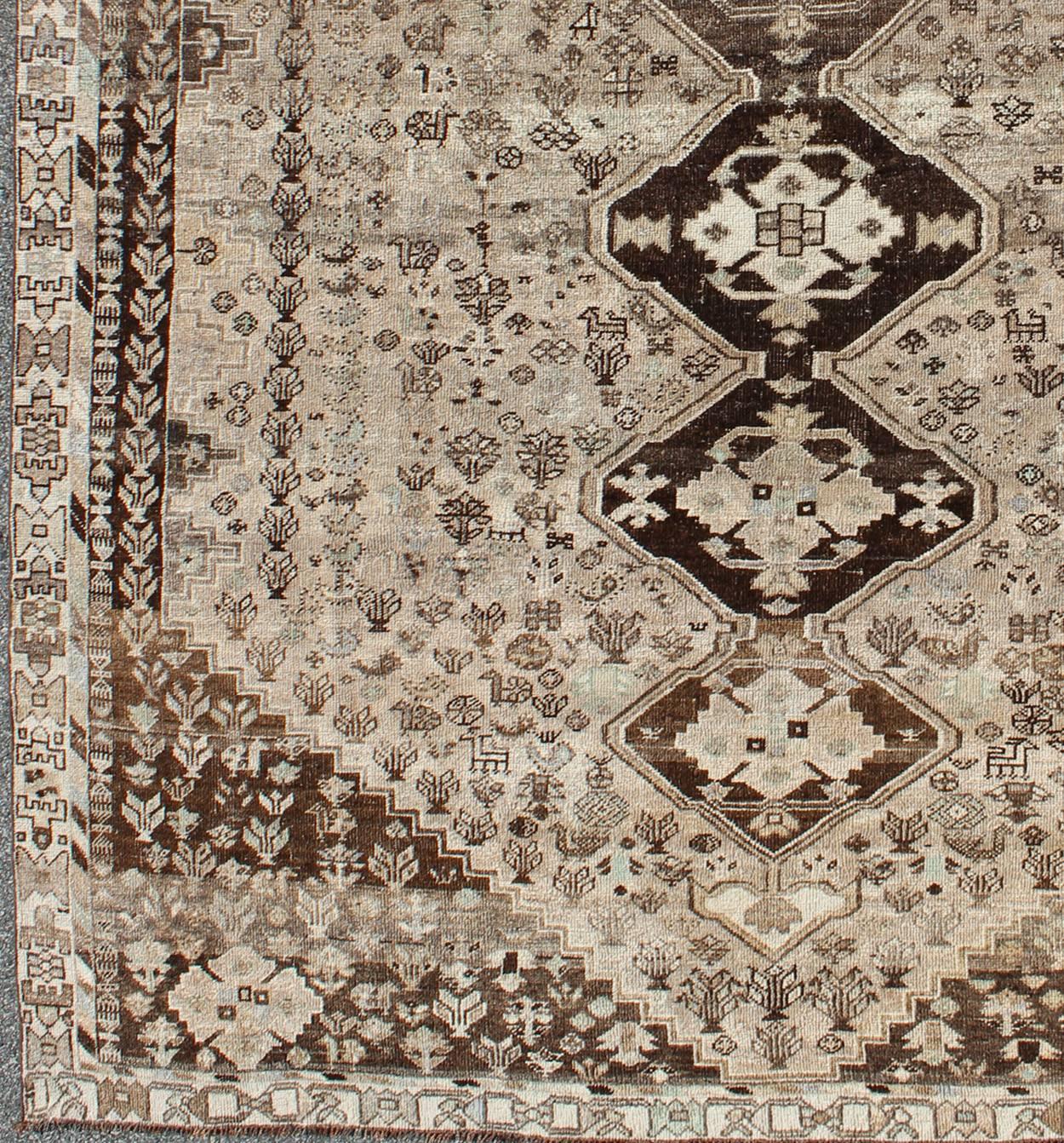 Brown/Taupe Vintage Persian Shiraz rug with Vertical Sub-Geometric Medallions, rug DSP-A342934, country of origin / type: Iran / Shiraz, circa 1950

This vintage Persian Shiraz rug (circa 1950) features a unique blend of colors and an intricately