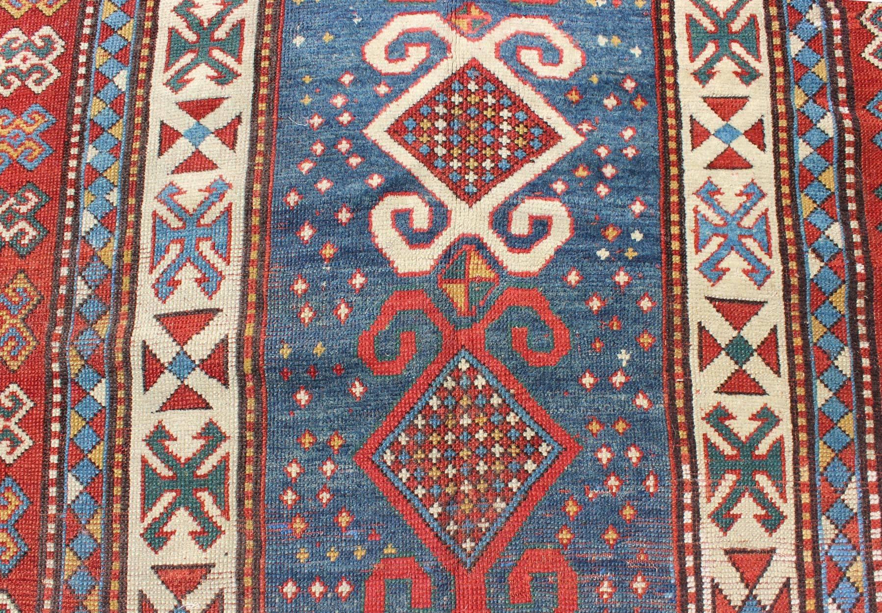 Hand-Knotted Red and Blue Antique Caucasian Kazak Rug with Vertical Tribal Medallions For Sale