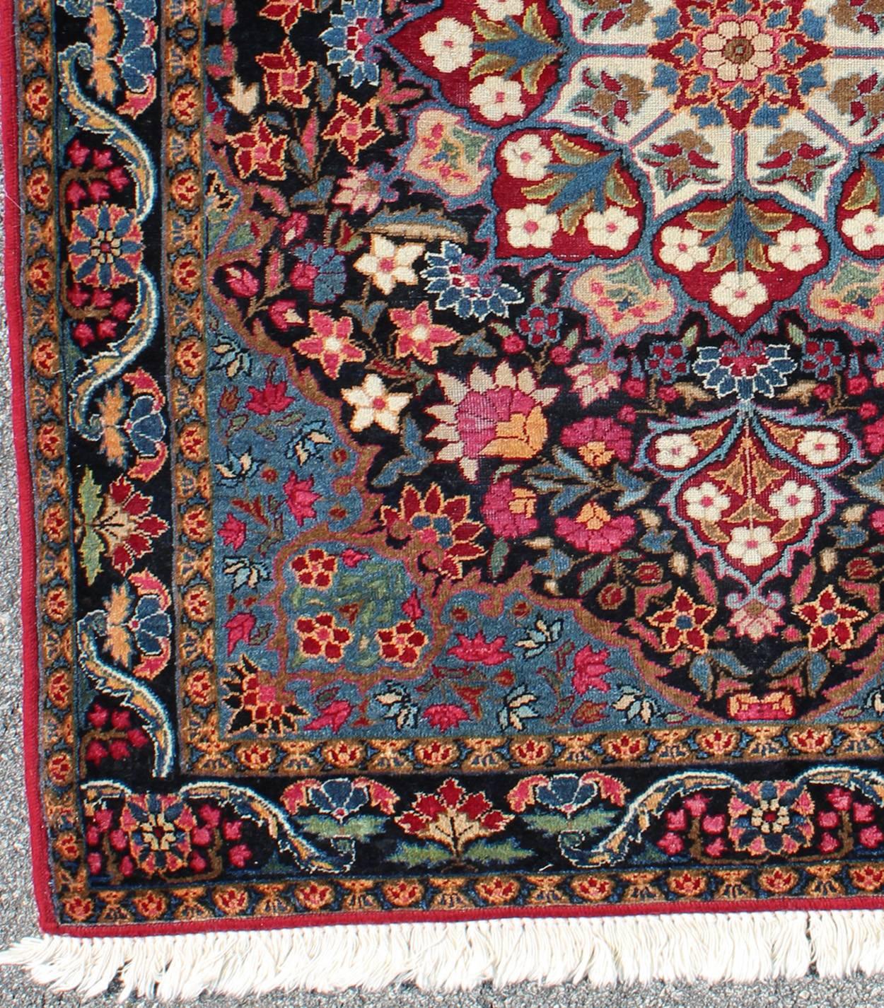 Blooming Floral Medallion vintage Persian Kerman rug with multi-colors, rug emac-004, country of origin / type: Iran / Kerman, circa 1940s

This vintage Persian Kerman rug, circa 1960 from the mid-20th century, features a light blue corners, which
