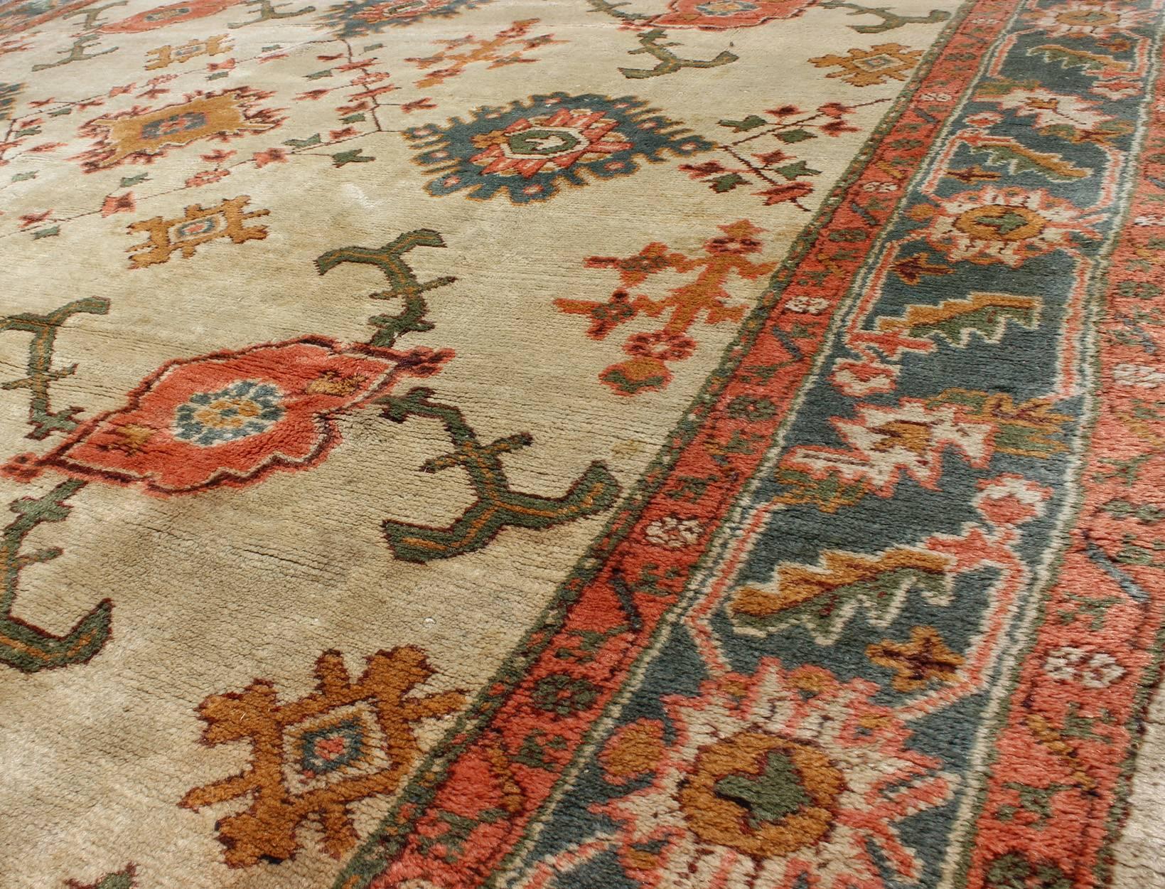 20th Century Antique Turkish Oushak Rug With All Over Design in Teal, Cream & Coral For Sale