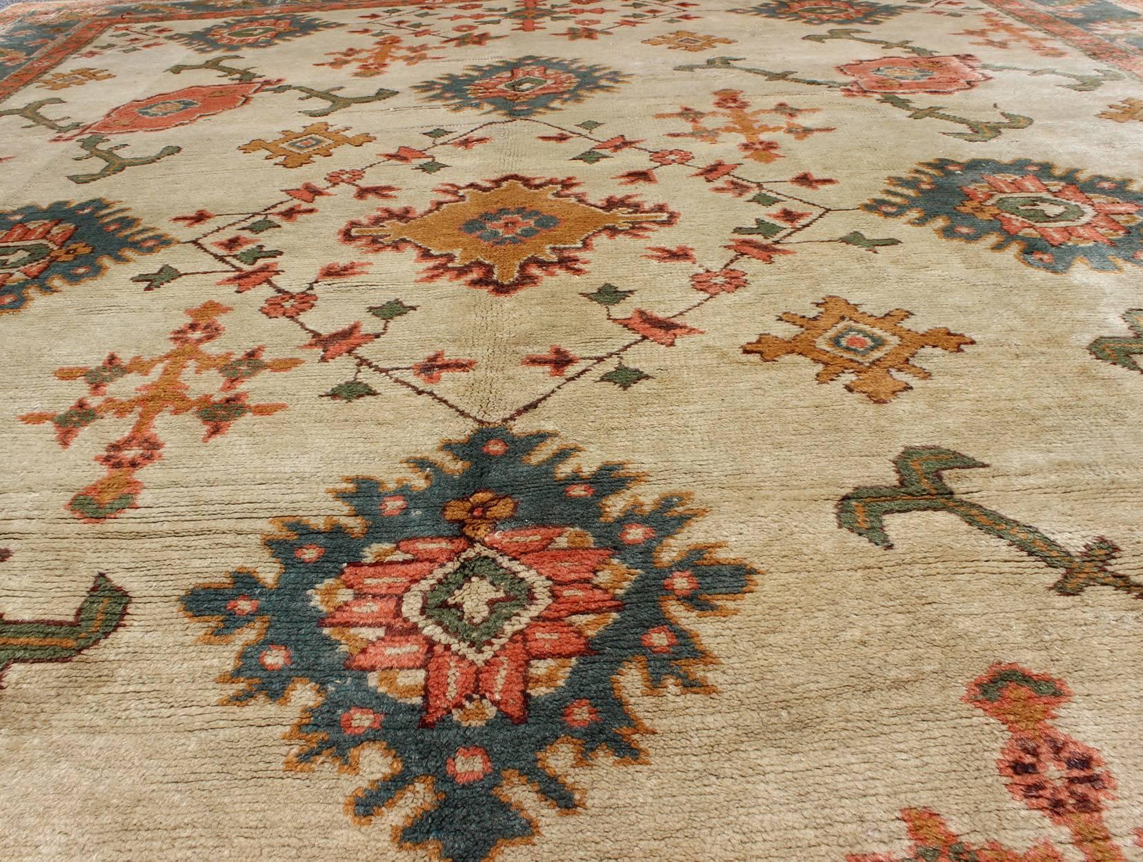 Wool Antique Turkish Oushak Rug With All Over Design in Teal, Cream & Coral For Sale