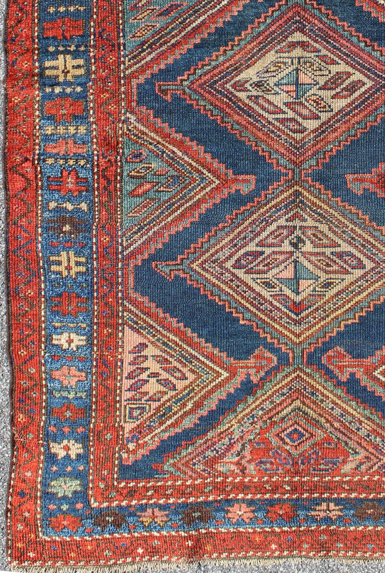 Jewel-toned antique N.W. Persian tribal Malayer rug with diamond medallion design, rug h8-0407, country of origin / type: Iran / N.W. Persian Tribal, circa 1910

This jewel-toned antique N.W. Persian rug, circa 1910, features a unique blend of