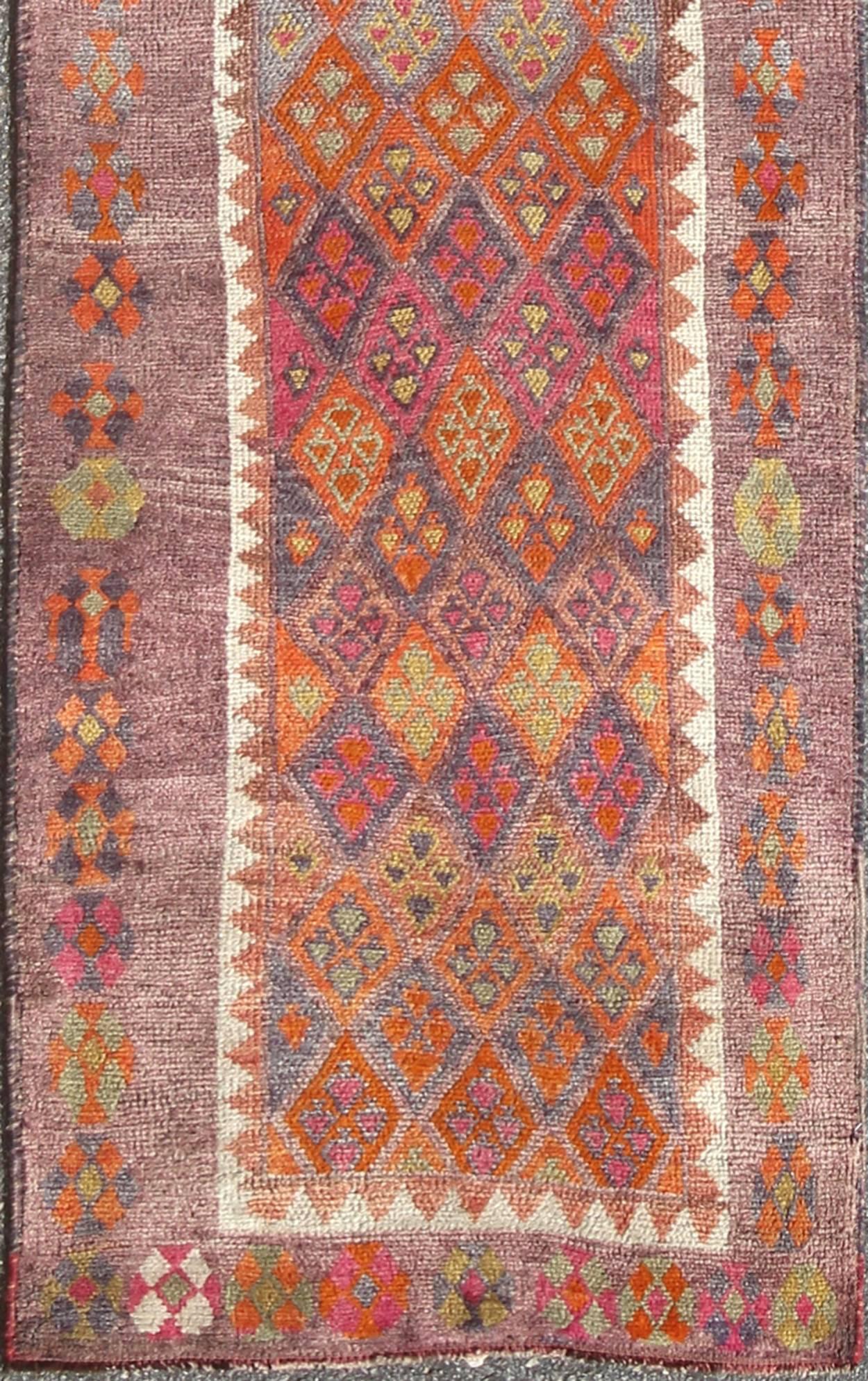 Colorful vintage Turkish oushak runner with repeating diamond geometric design, rug en-165369, country of origin / type: Turkey / Oushak, circa 1950

This vintage Oushak runner (circa mid-20th century) features a unique blend of colors and an
