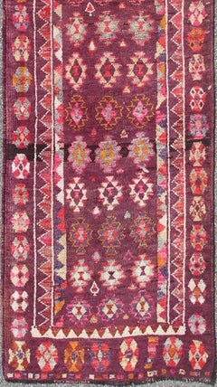 Colorful vintage Turkish Oushak Long runner in Purple & Plum background