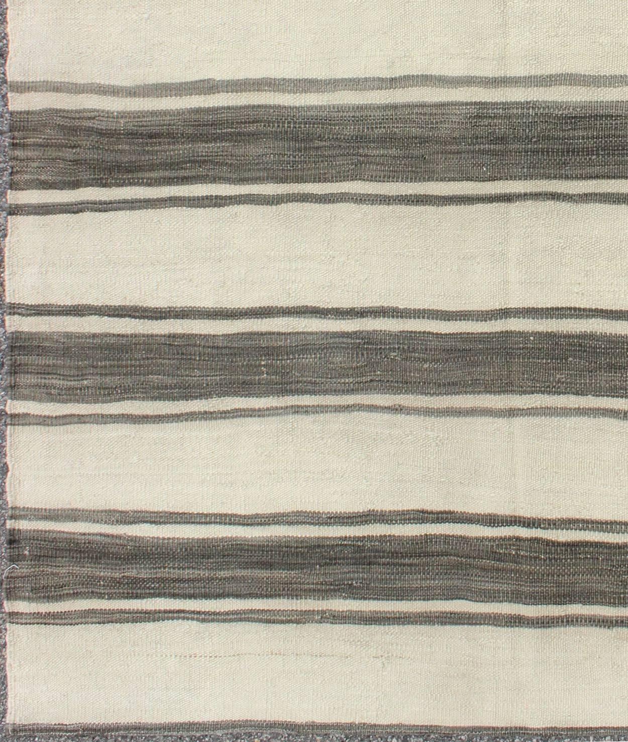 Modern design vintage Turkish Kilim rug in cream with horizontal gray stripes, rug en-165668, country of origin / type: Turkey / Kilim, circa mid-20th century

Woven during the mid-20th century in Turkey, this designer Kilim is decorated with a