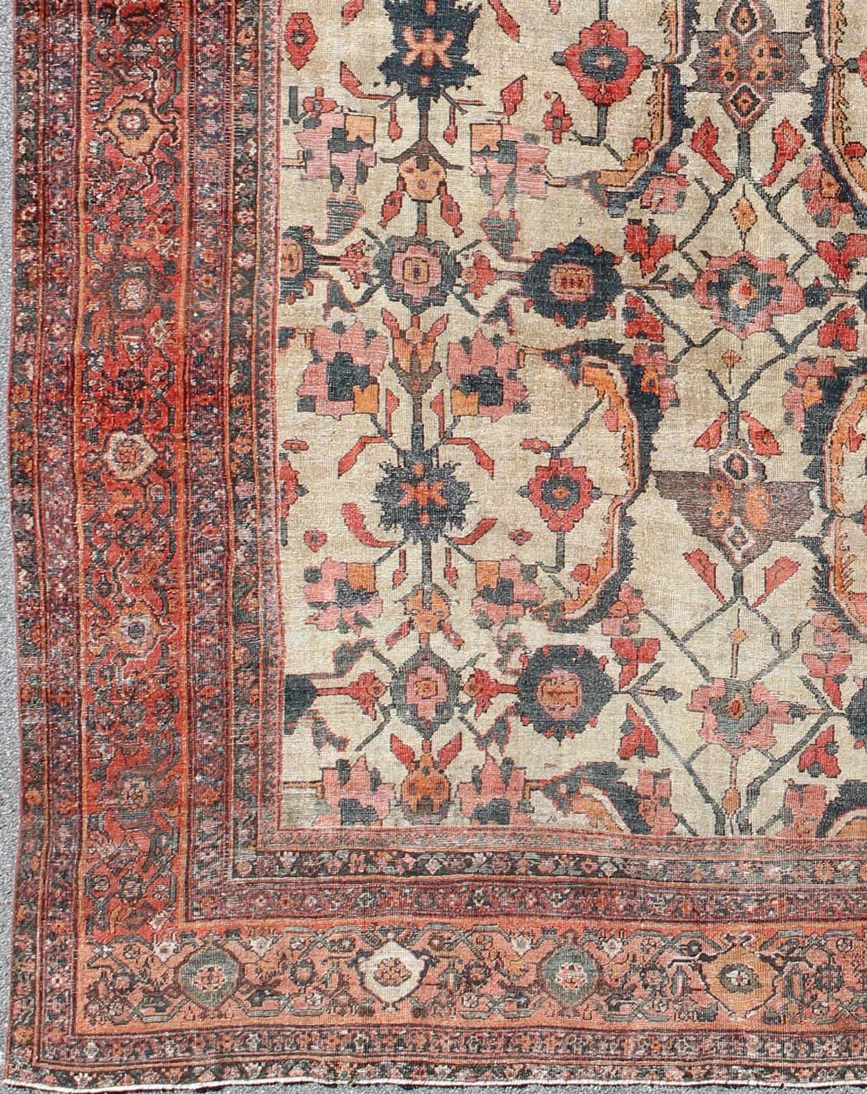 Antique Persian Sultanabad rug with vining floral pattern in ivory background along with red, orange, gray blue and charcoal. Keivan Woven Arts /  rug NA-170090, country of origin / type: Iran / Sultanabad, circa 1880s. 
Measures: 12'6 x 16'6.
This