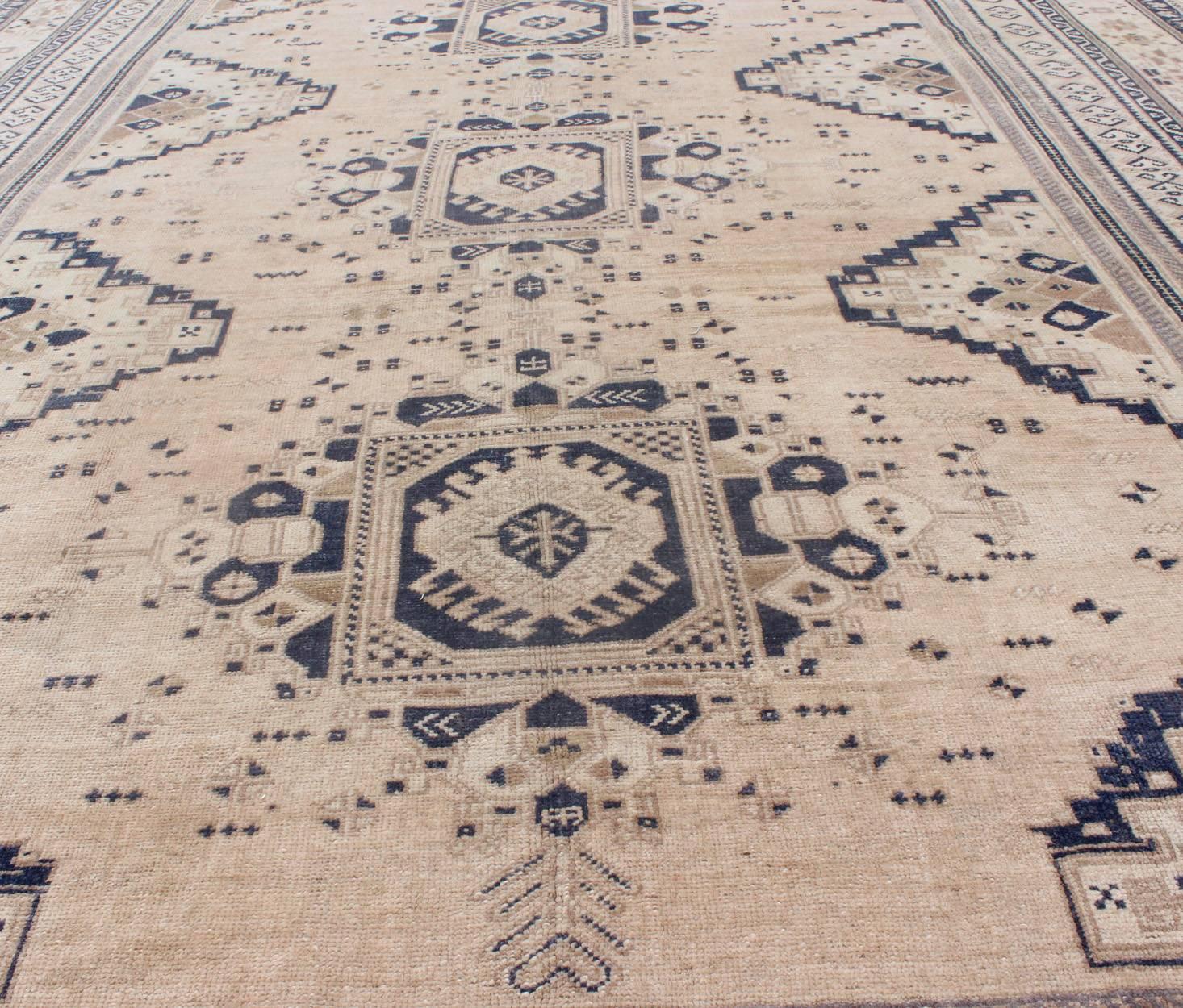 Mid-20th Century Light Blush and Navy Blue Vintage Turkish Oushak Rug with Tri-Medallion Design For Sale