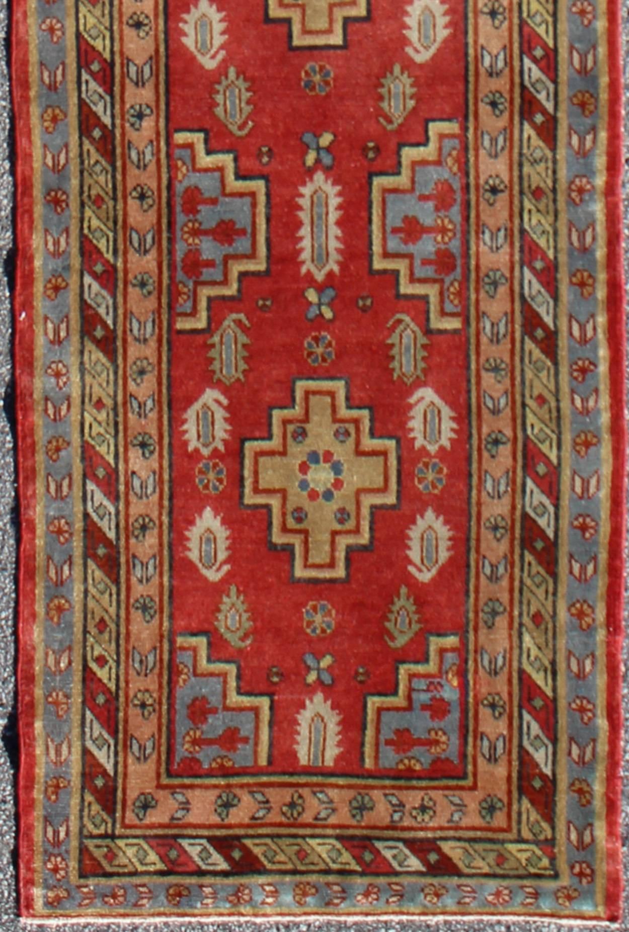 Antique Khotan Runner from Turkestan with four geometric medallions in red and multi colors, rug tu-mtu-4648, country of origin / type: East Turkestan / Khotan, circa 1920

This geometric antique Khotan rug was handcrafted in Turkestan during the