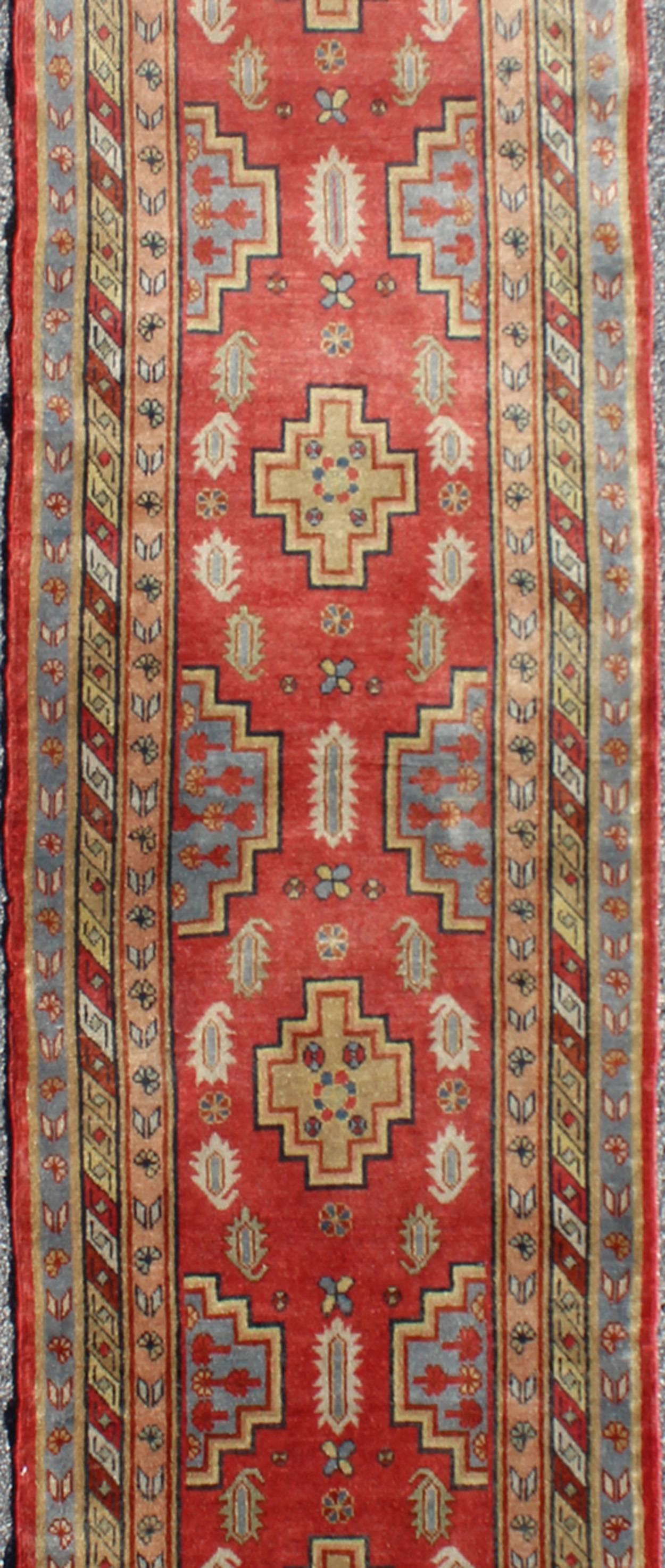 Hand-Knotted Antique Khotan Runner from Turkestan with Geometric Medallions in Red Background For Sale