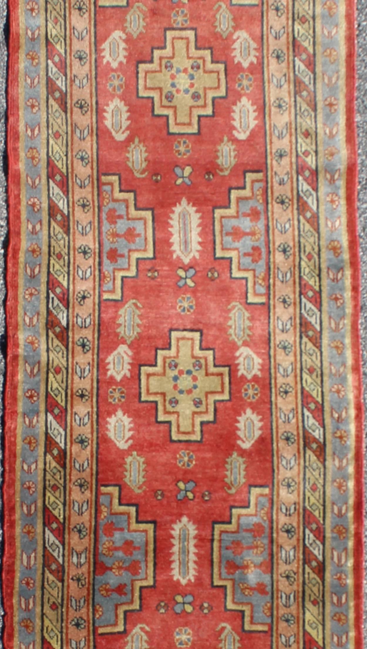 Antique Khotan Runner from Turkestan with Geometric Medallions in Red Background In Excellent Condition For Sale In Atlanta, GA