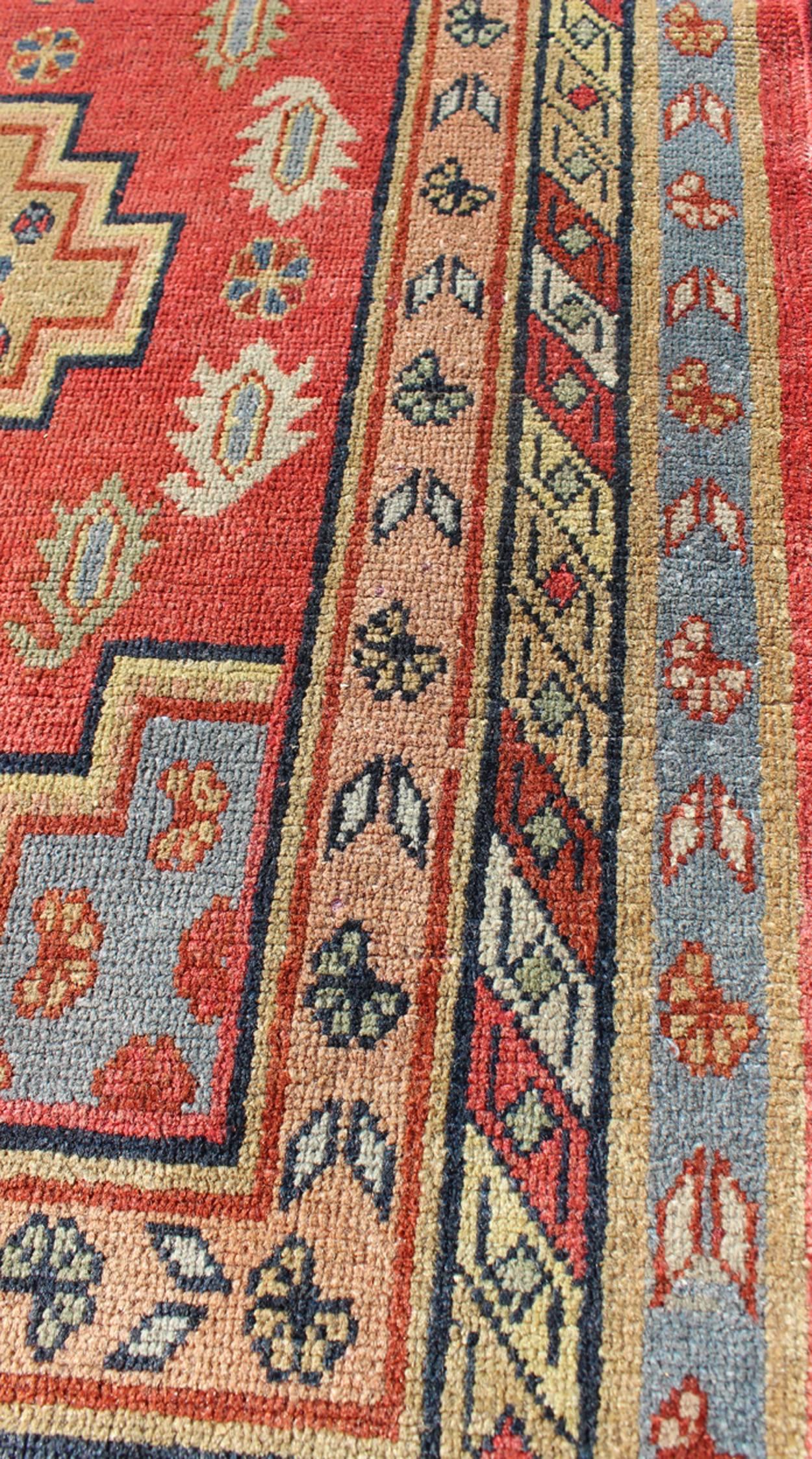 Early 20th Century Antique Khotan Runner from Turkestan with Geometric Medallions in Red Background For Sale