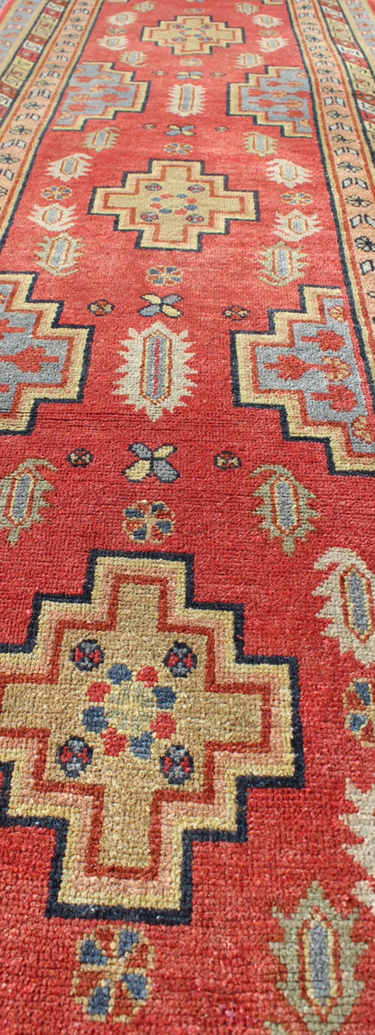 Wool Antique Khotan Runner from Turkestan with Geometric Medallions in Red Background For Sale