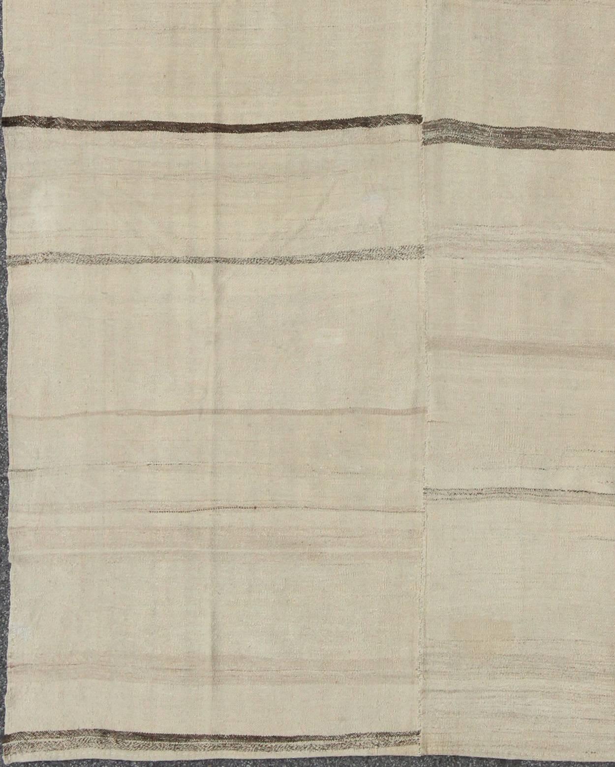Brown and cream horizontal stripe vintage Turkish Kilim rug of two panels, rug tu-ned-1113, country of origin / type: Turkey / Kilim, circa 1950

Made from two flat-weave panels that were sewn together, this mid-century vintage Kilim is set on an