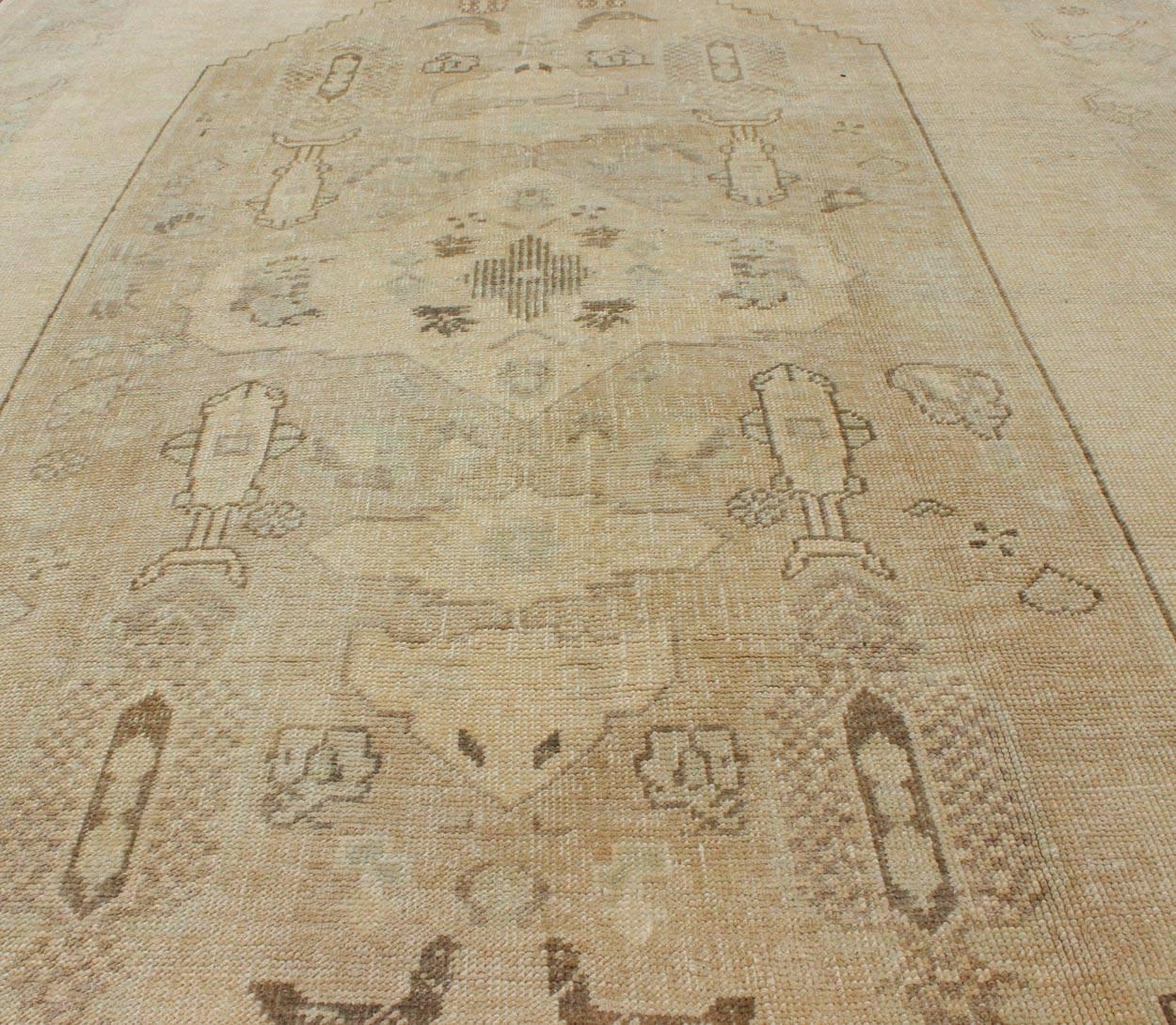 Wool Faded Turkish Oushak Rug with Central Medallion Design in Cream and Brown For Sale