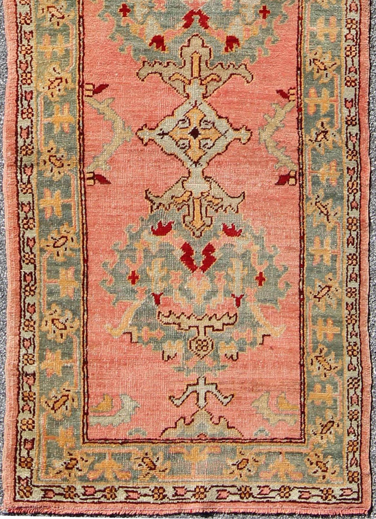 Early 20th century antique Turkish Oushak runner with medallions in coral background & green border, rug h8-0401, country of origin / type: Turkey / Oushak, circa 1920

This early 20th century antique Turkish Oushak runner displays beautiful