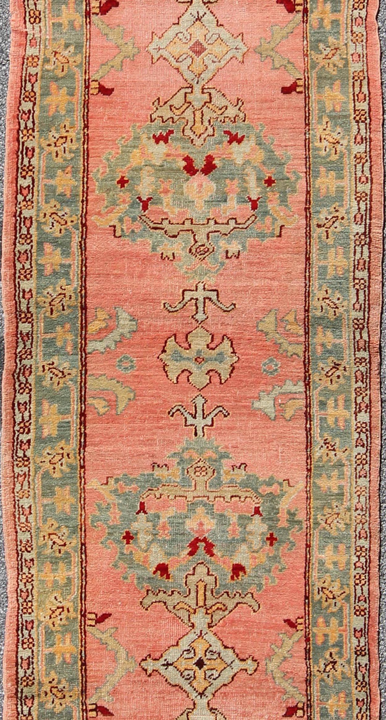 20th Century Antique Turkish Oushak Runner with Medallions in Coral Background & Green Border For Sale