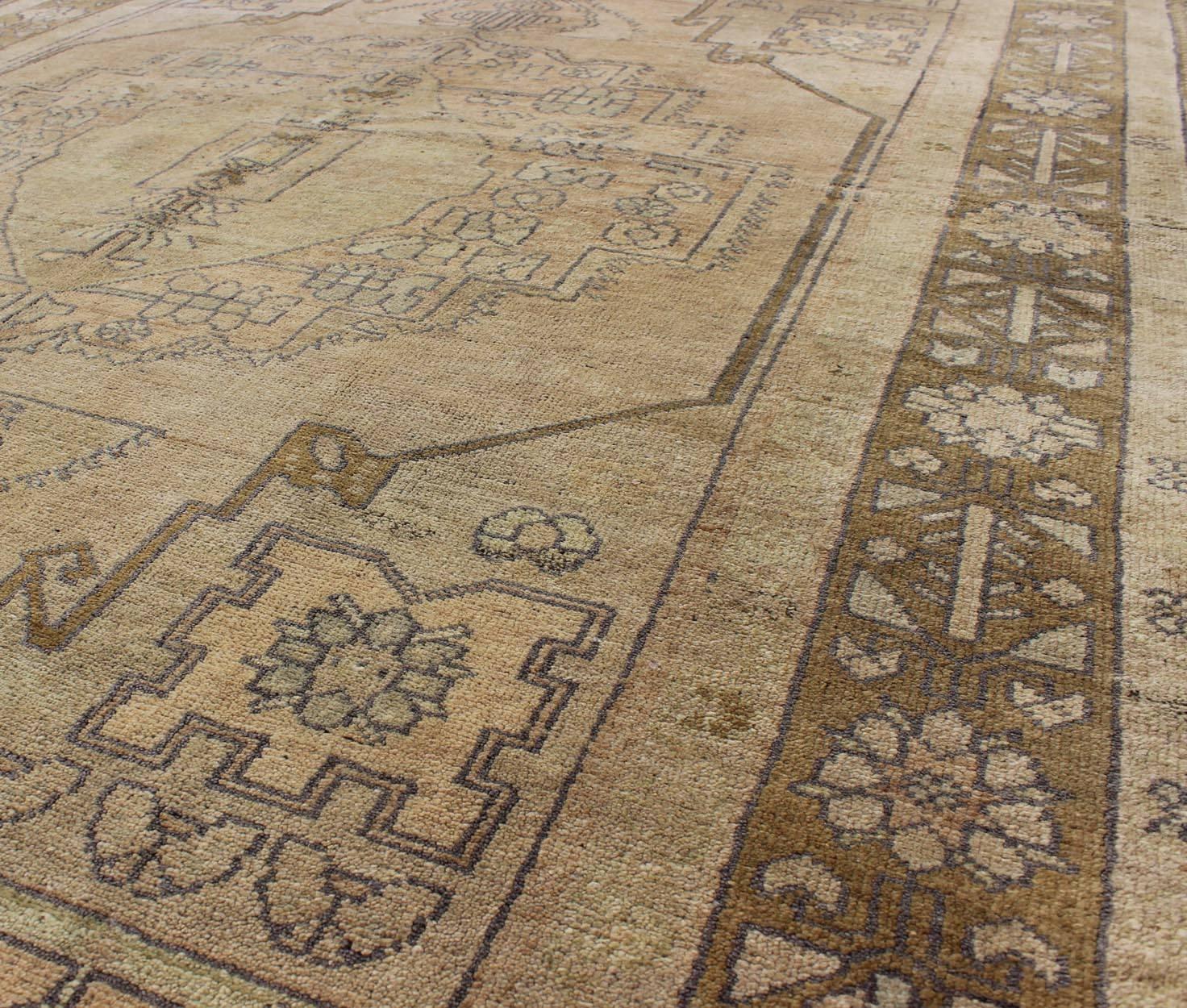 Mid-20th Century Vintage Turkish Oushak Rug in Soft Tones and Neutral Colors  For Sale