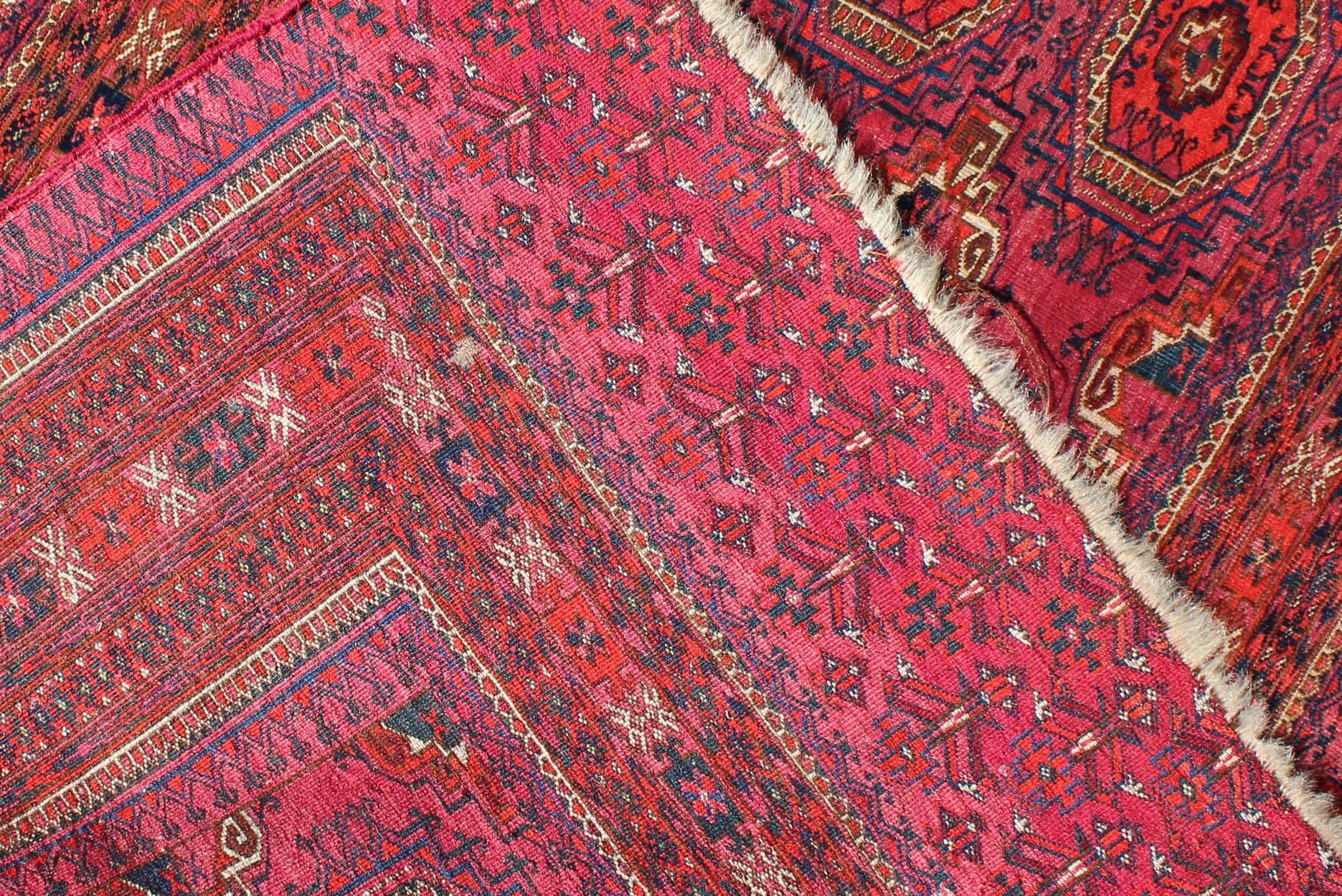 Antique Turkoman Tekke Rug with Repeating Medallion Design in Fuchsia In Excellent Condition In Atlanta, GA