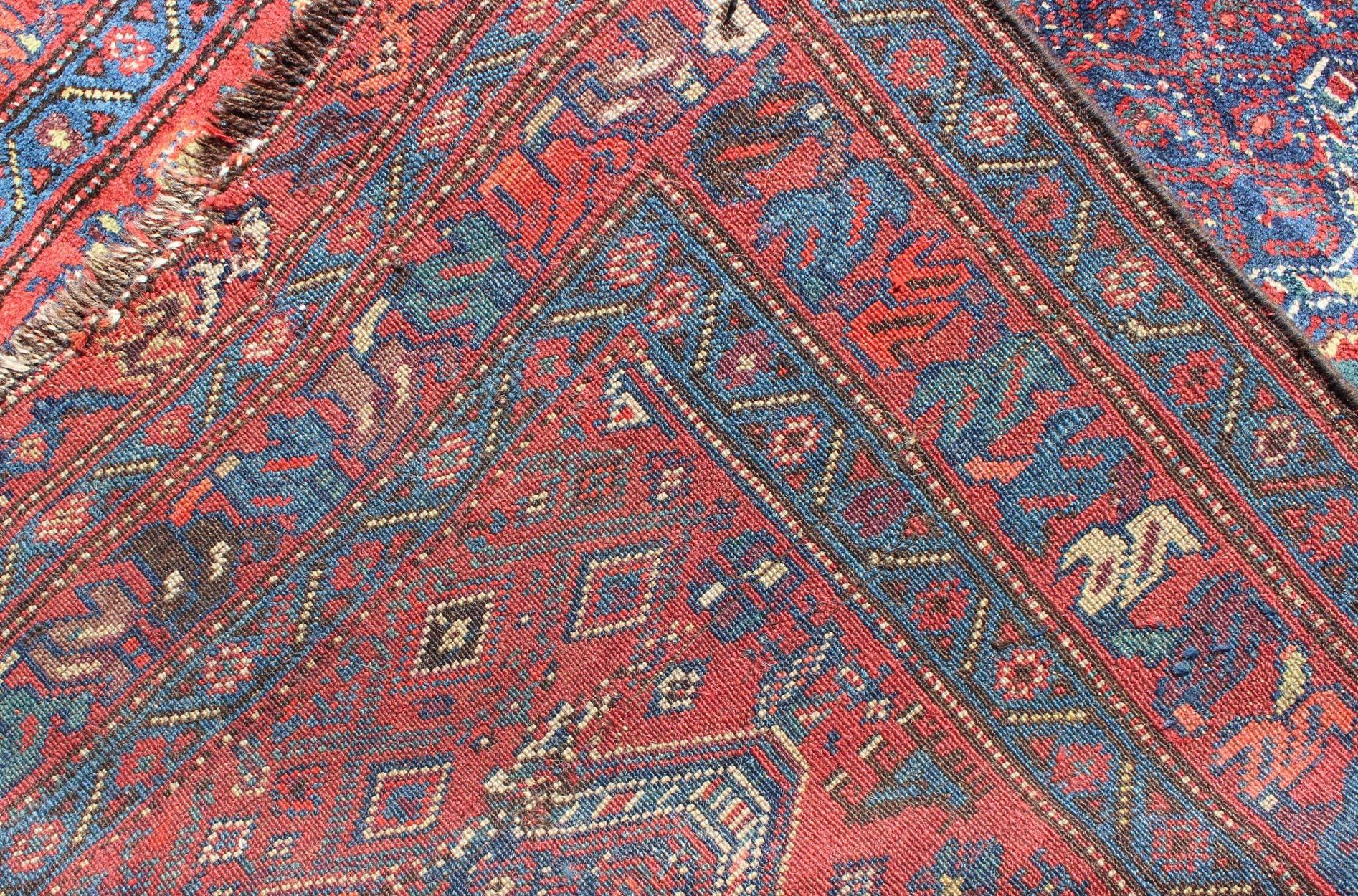 Early 20th Century Blue Background Antique N.W. Persian Rug with Zig-Zag Field and Tribal Motifs For Sale