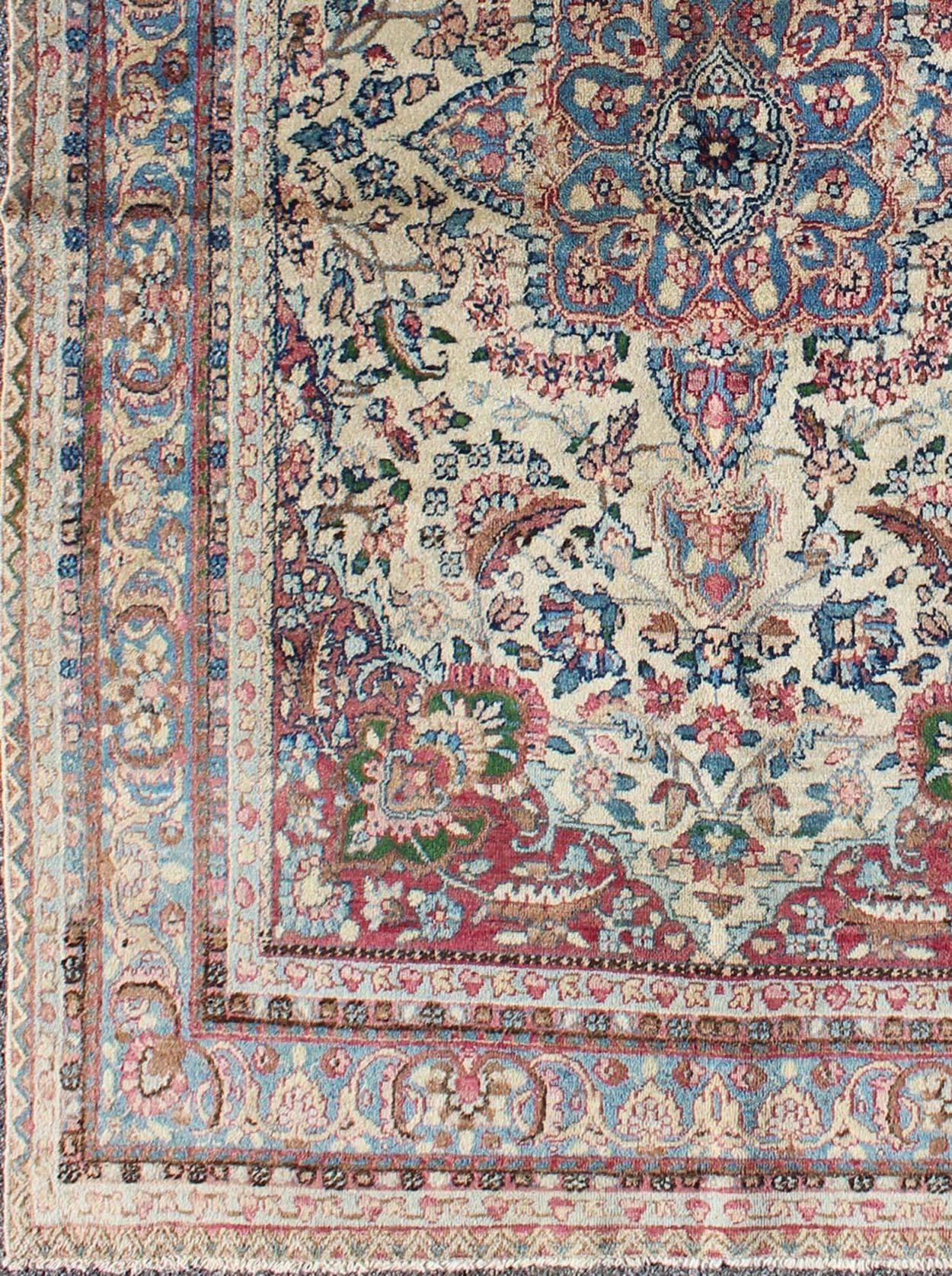 Ornately detailed antique Persian Lavar Kerman rug with fldral Design, rug e-0905, country of origin / type: Iran / Lavar Kerman, circa 1910.

This large, antique Persian Lavar Kerman rug features an ornate royal blue centre medallion. The ivory