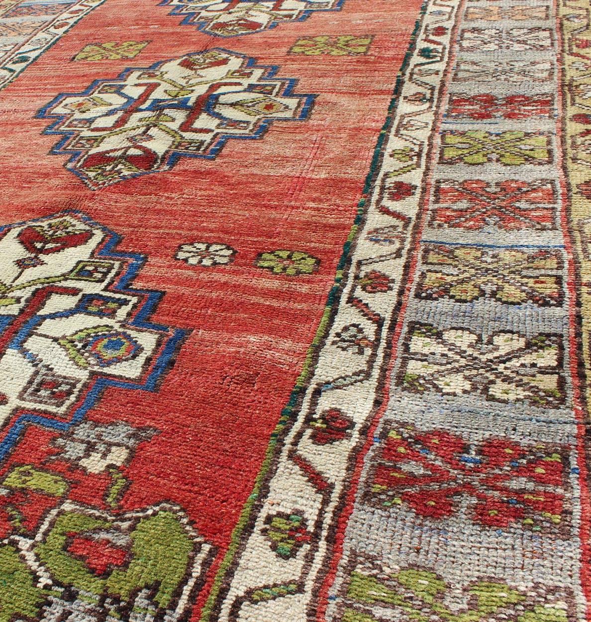 Mid-20th Century Green, Blue and Red Vintage Turkish Oushak Rug with Three Geometric Medallions For Sale