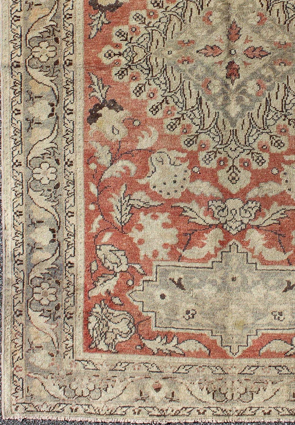 This fine Turkish Oushak carpet form the 1930s boasts an impressive multi-layered, diamond-shaped central medallion. An exquisite display of stylized floral motifs complemented by a subdued palette of colors fills the body of the rug. An elegant