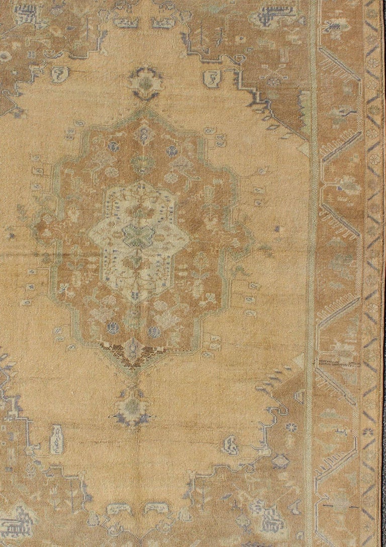 Faded Vintage Turkish Oushak Rug with Layered Medallion For Sale at 1stDibs