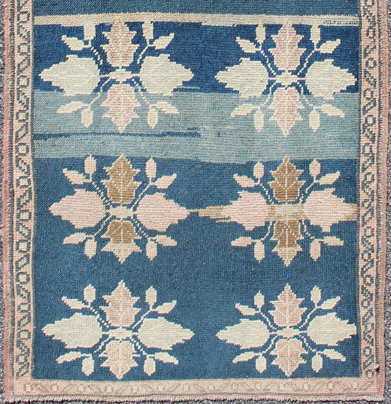 Multi-medallion floral midcentury Turkish Oushak runner in blue and pink, rug en-112252, country of origin type: Turkey Tulu, circa 1950

This Oushak carpet (circa mid-20th century) features a multitude of blossom medallions spread throughout the