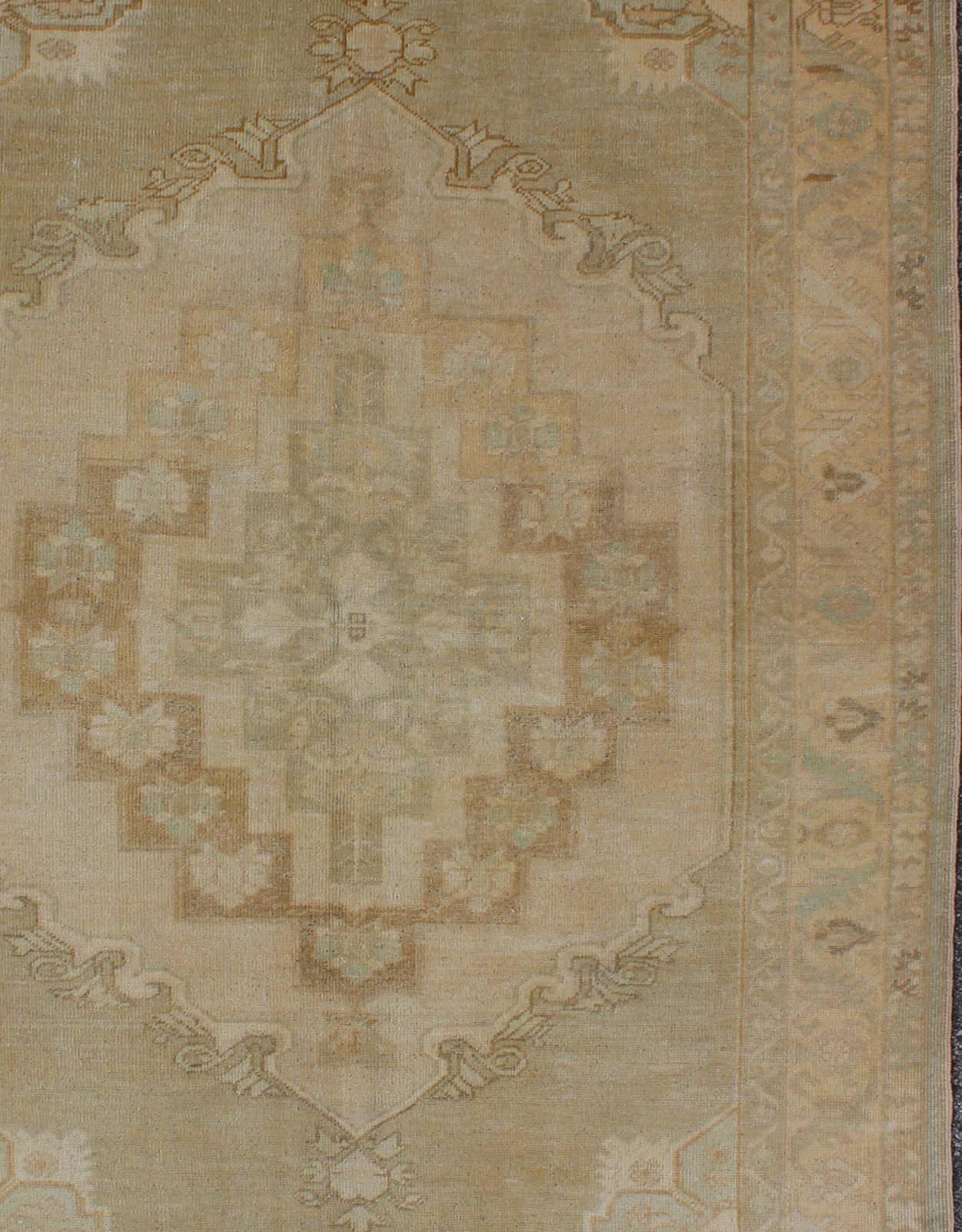 Hand-Knotted Faded Vintage Turkish Oushak Rug with Layered Medallion in Creams and Grays For Sale