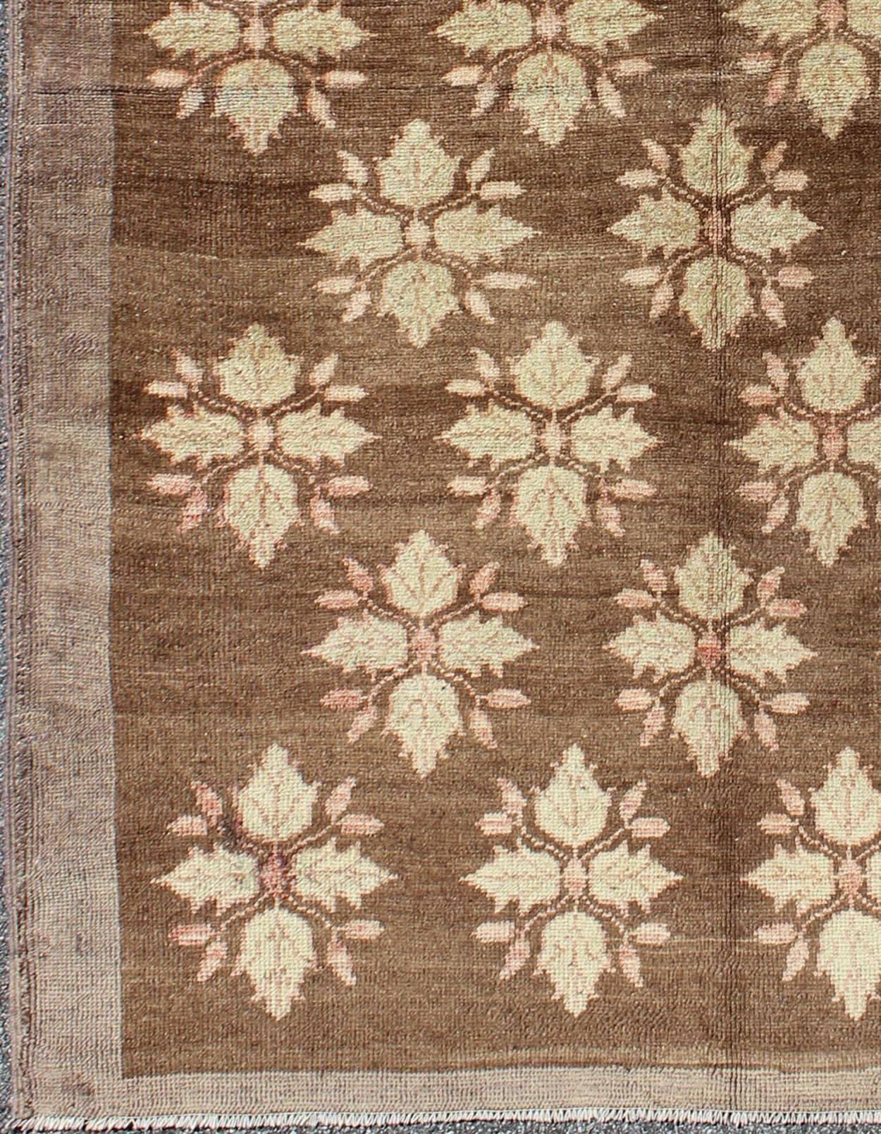 Midcentury Turkish Tulu rug with mini blossom medallions in brown and ivory, rug en-112920, country of origin type: Turkey Tulu, circa 1950

This Tulu carpet (circa mid-20th century) features an all-over pattern of mini blossom-like flowers
