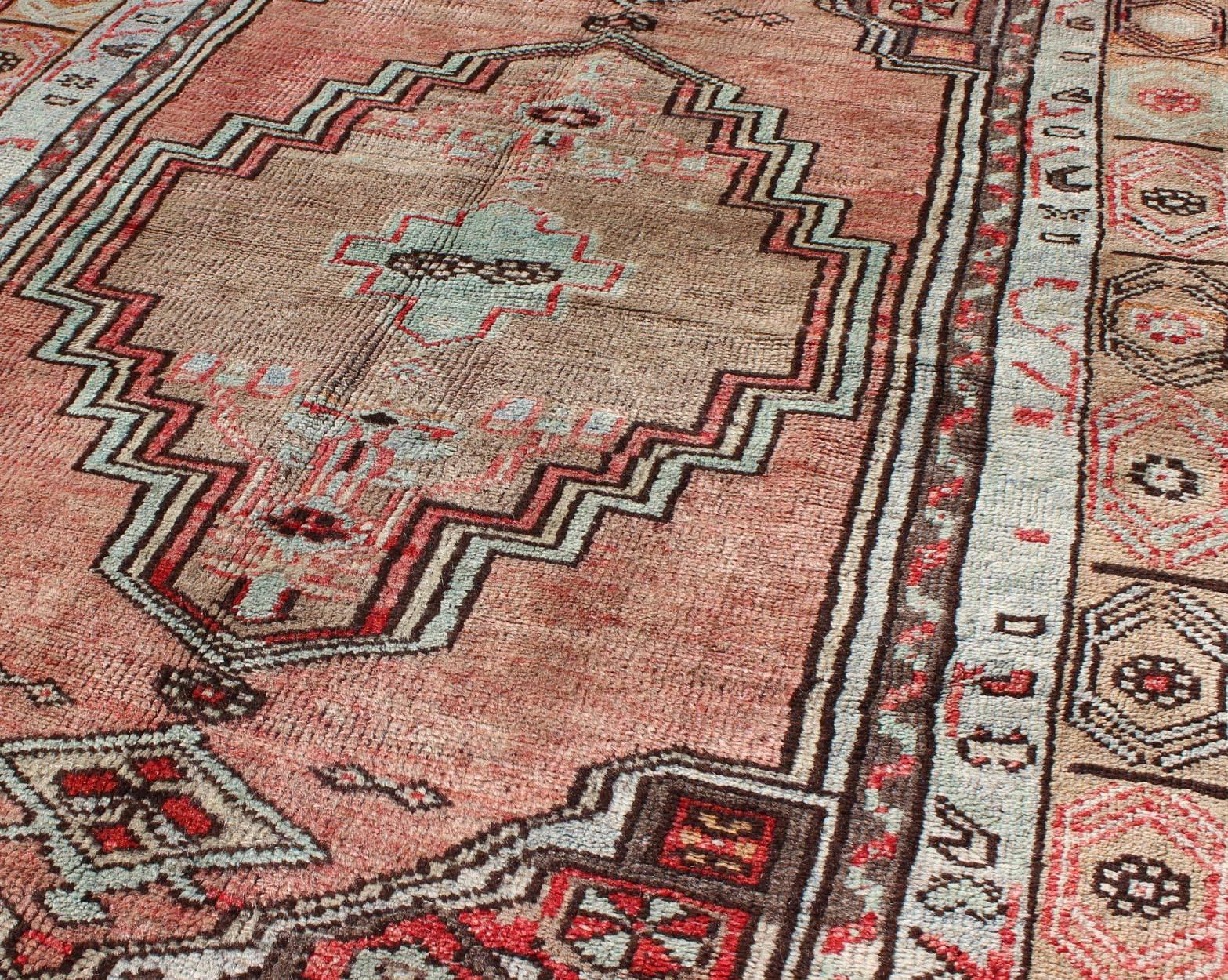 Mid-20th Century Salmon and Pink Vintage Turkish Oushak Rug with Tribal Medallion Design For Sale