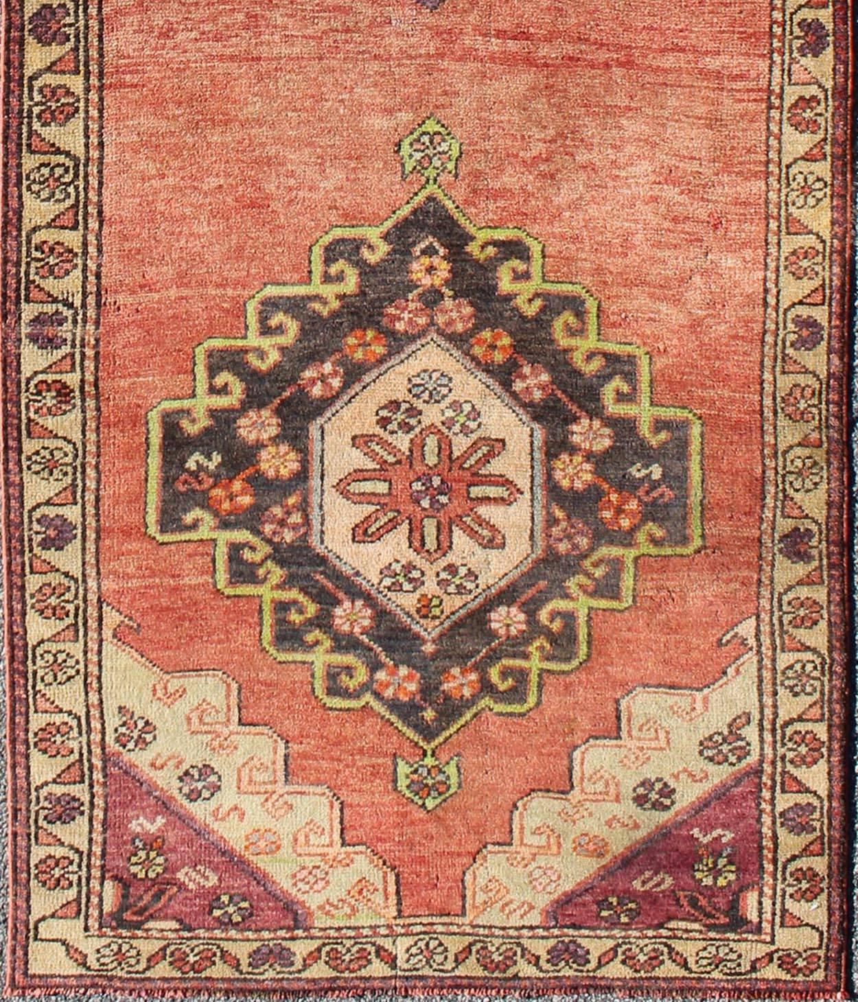 This vintage Oushak runner features a unique blend of cheerful colors and an intricately beautiful design. The sub-geometric, multi-layered diamond medallions are complemented by other sub-geometric elements in the surrounding cornices and border.