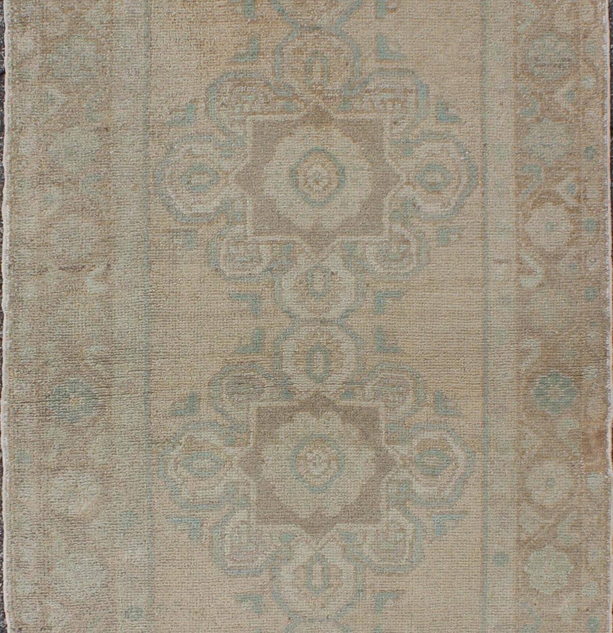 Hand-Knotted Floral Medallion Vintage Turkish Oushak Runner with Faded Color Palette For Sale