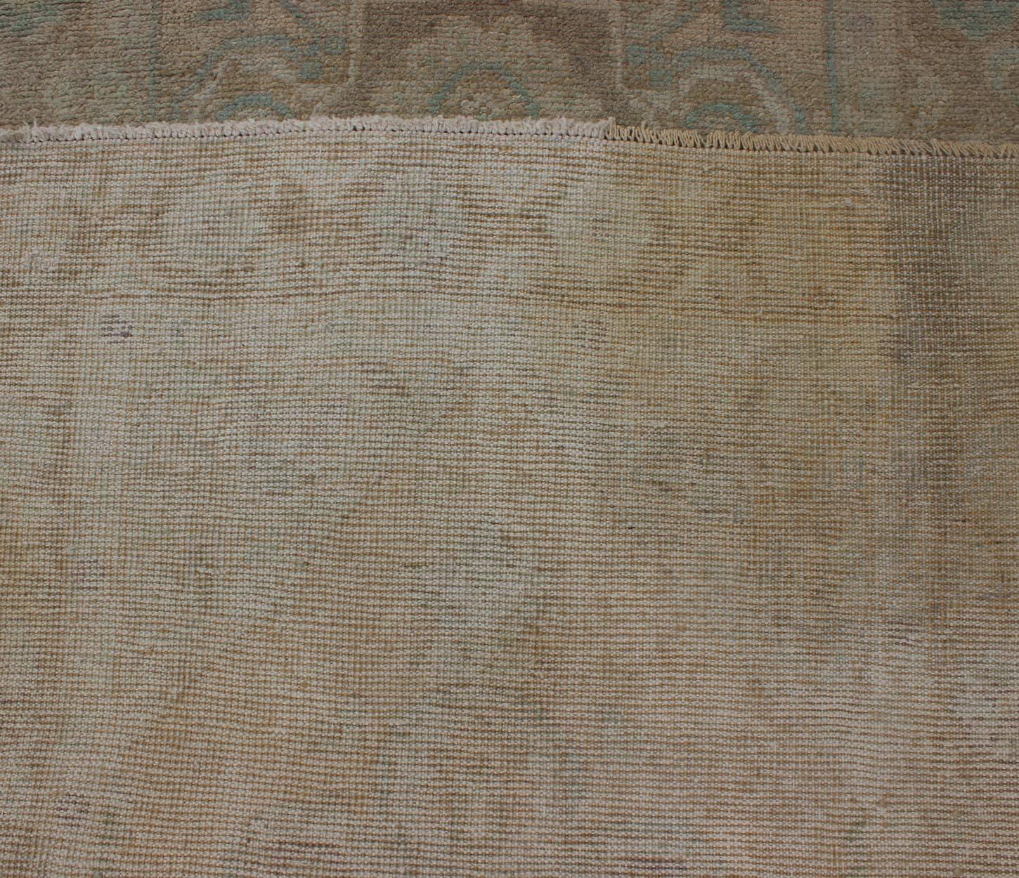 Mid-20th Century Floral Medallion Vintage Turkish Oushak Runner with Faded Color Palette For Sale