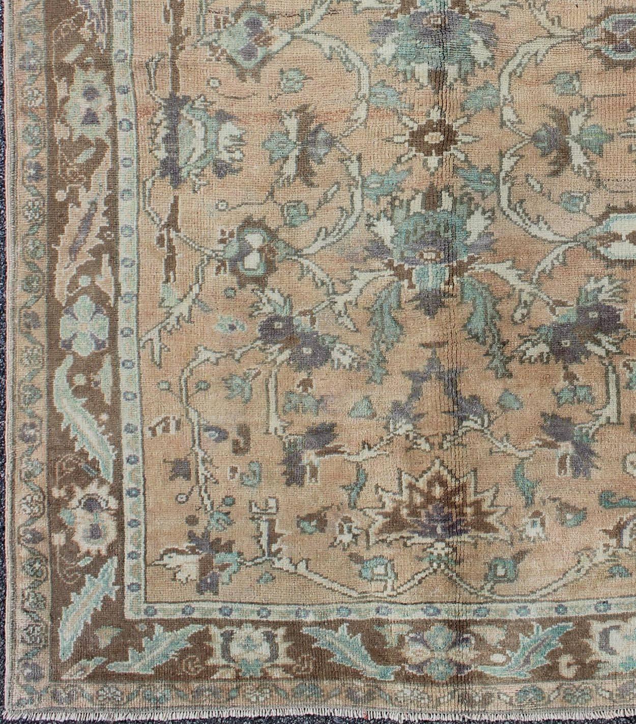 Elegant floral vintage Turkish Oushak rug in cream, green, peach, and brown, rug enc-4090, country of origin / type: Turkey / Oushak, circa 1930

The design of this beautiful vintage Oushak rug from Turkey and neutral color palette, punctuated with