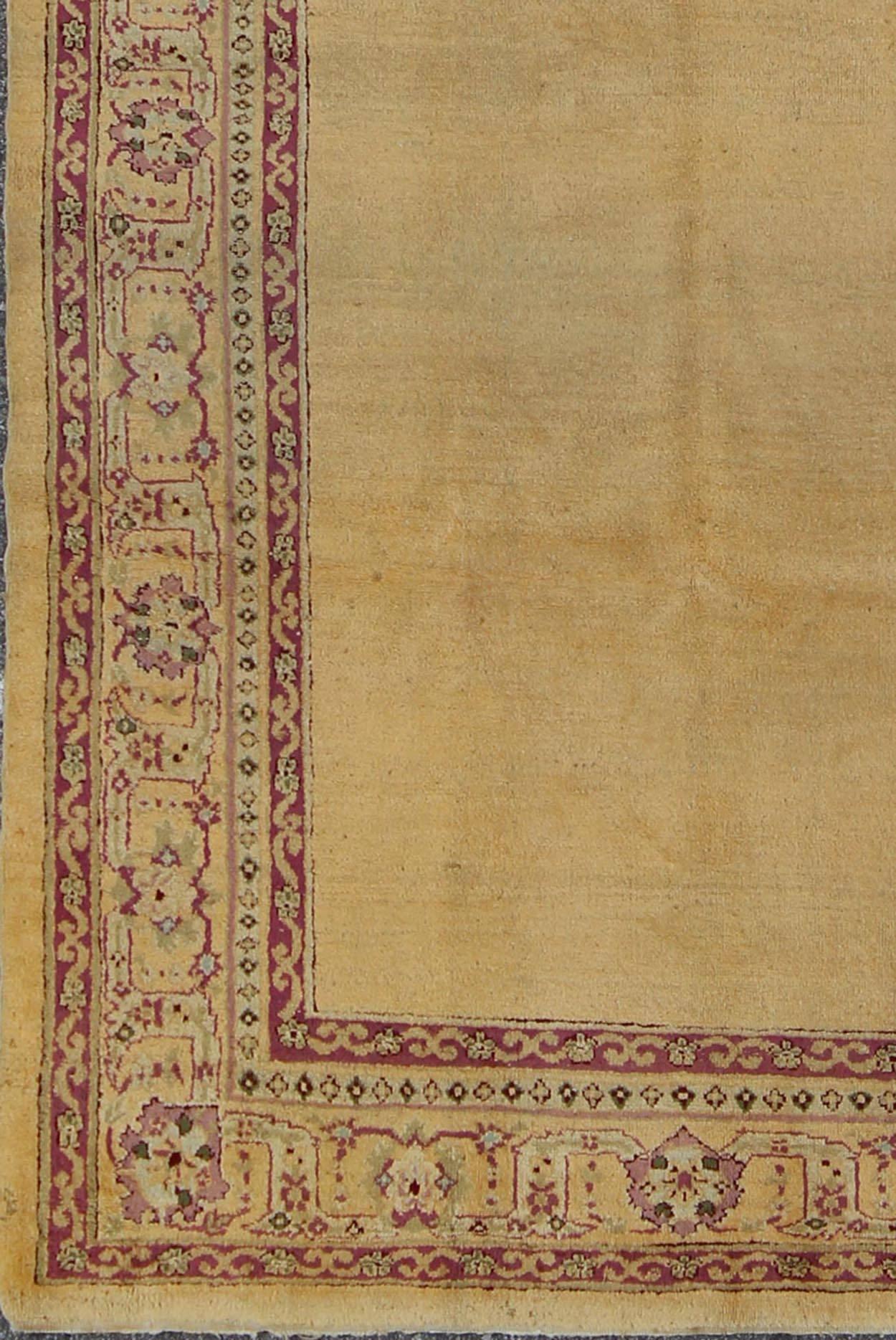 Antique Indian Amritsar rug with solid field of creamy yellow and ornate lavender and red border, Keivan Woven Arts / rug G-0206, country of origin / type: India / Amritsar, circa 1910

This carpet was woven in Amritsar in the early 20th century