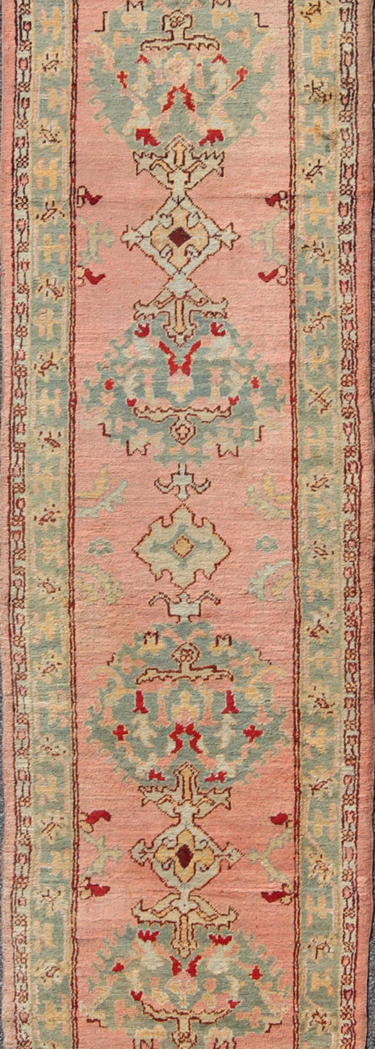 Hand-Knotted Salmon Pink Antique Turkish Oushak Runner with Stylized Floral Medallion Design For Sale