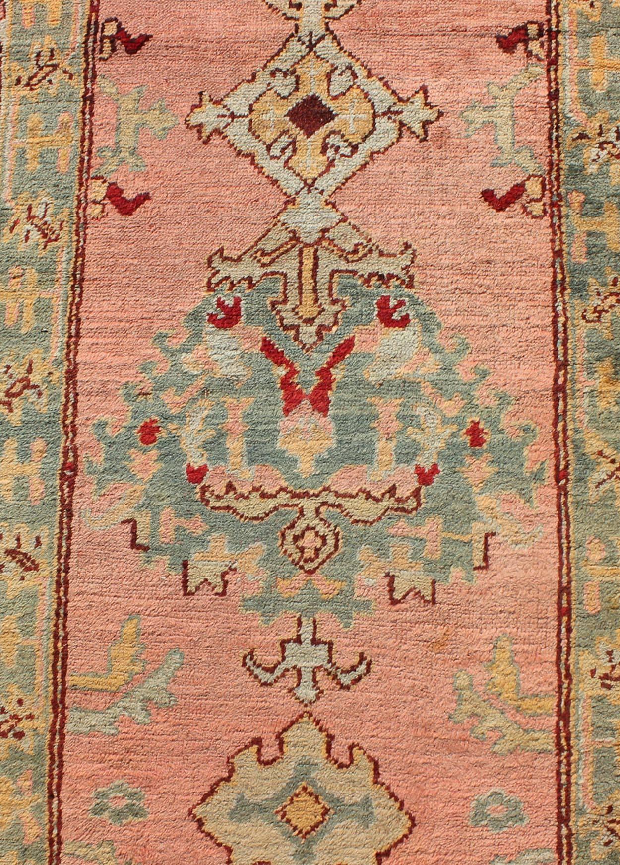 Wool Salmon Pink Antique Turkish Oushak Runner with Stylized Floral Medallion Design For Sale